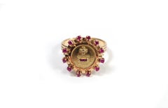 Augis halo ruby ring in 18k gold, more than yesterday less than tomorrow