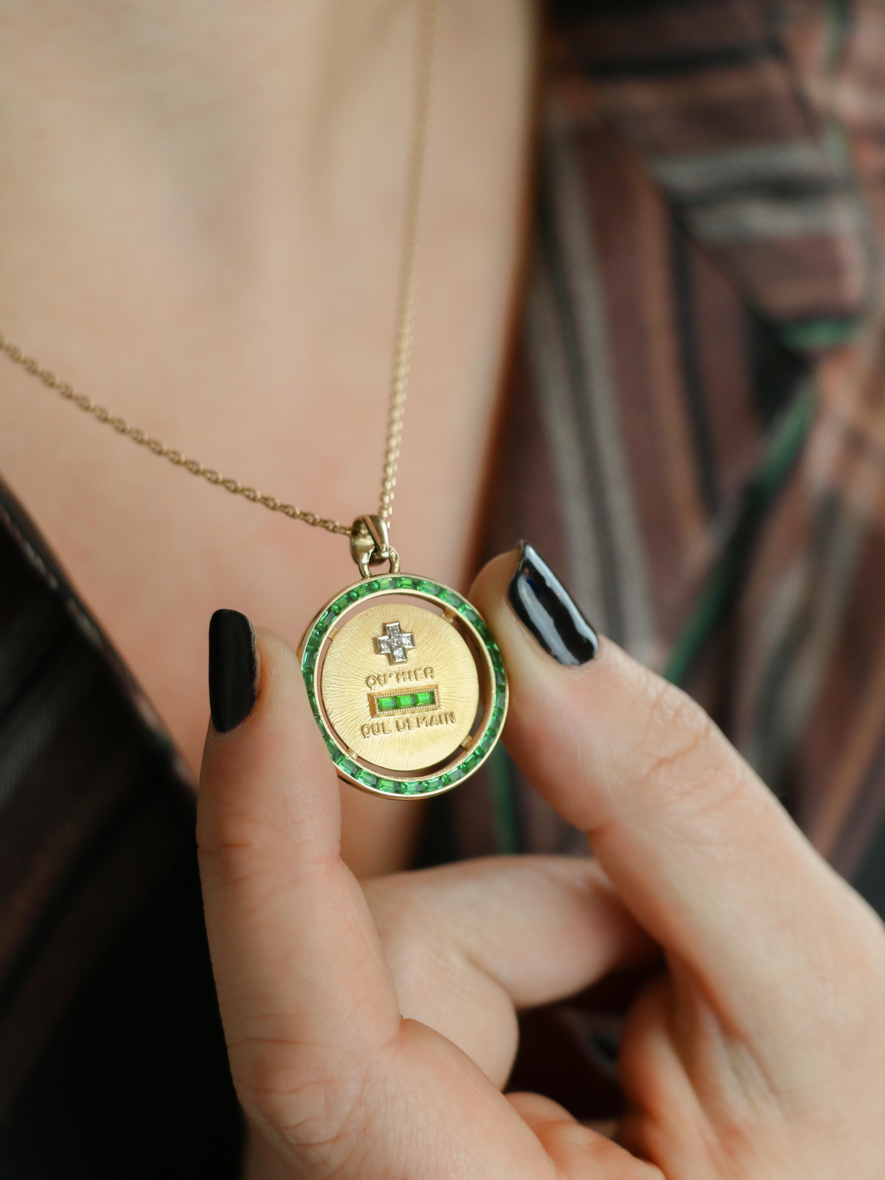 Vintage Augis Love Medal in 18k gold (750°/°°) set with 5 diamonds and 3 calibrated emeralds, probably synthetic, surrounded by calibrated emeralds, also likely synthetic. Vintage work signed A.A. Presence of eagle head hallmark for 18-carat gold