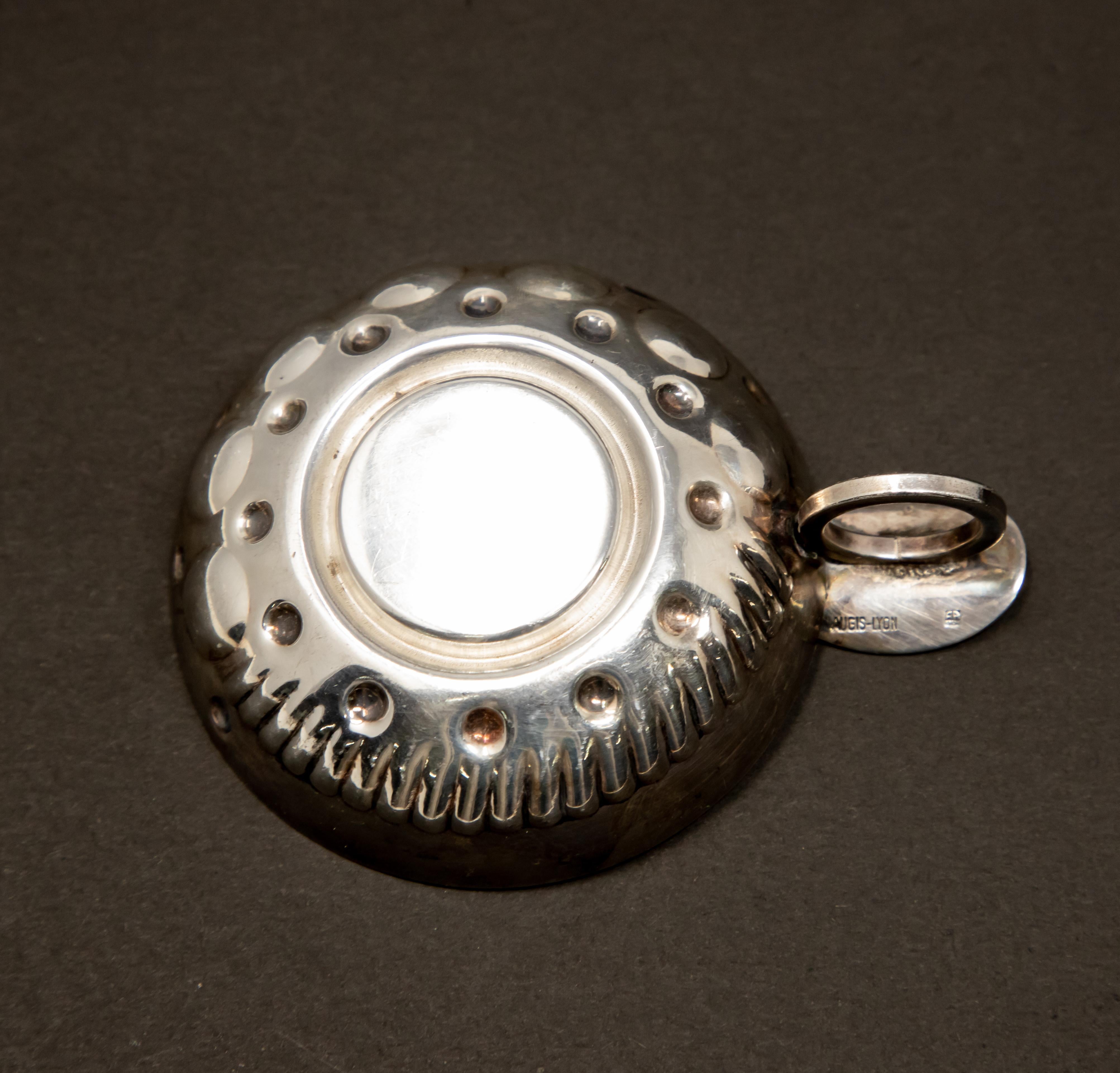 Offering this beautiful Augis-Lyon sterling silver wine taster. The inside medallion is motorized vehicle with Berliet 1897, and behind the back wheel is marked Augis. The handle is a ring with a plate on top. The back of this plate is marked with