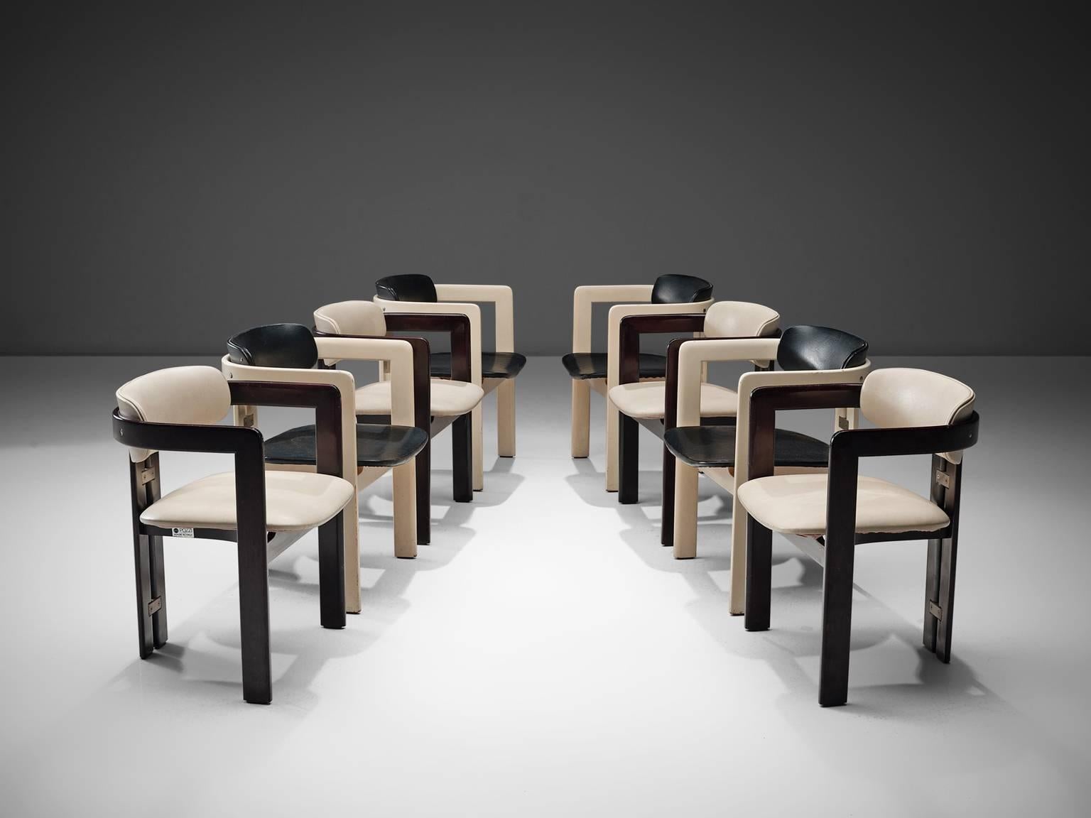 Augusto Savini for Pozzi, set of eight 'Pamplona' dining room chairs, white and black leatherette, ash wood and metal, Italy, 1965. 

Set of eight armchairs in ash wood and white and black leatherette upholstery. The chairs have a unique and
