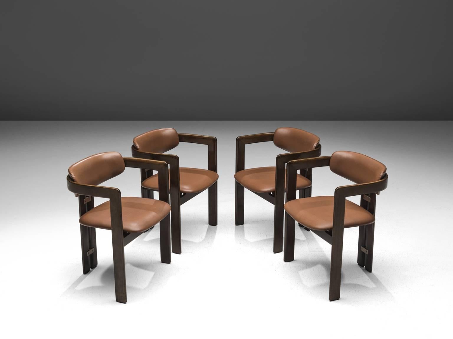 Augusto Savini for Pozzi, set of four 'Pamplona' dining room chairs, in cognac leather, ash and metal, Italy, 1965. 

Set of four armchairs in ash wood and the original cognac leather upholstery. The chairs have a unique and characteristic design;