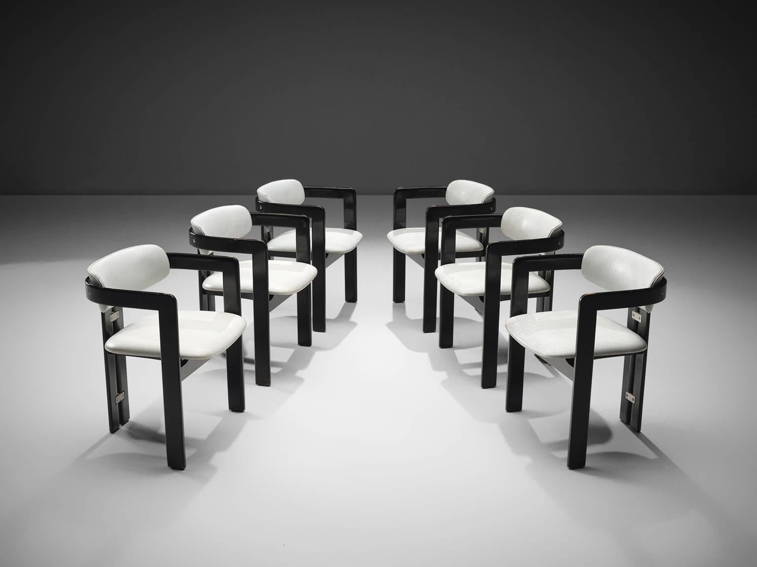 Augusto Savini for Pozzi, set of six 'Pamplona' dining room chairs, in white leather, dark glossed wood and metal, Italy, 1965. 

Set of six armchairs in dark glossed wood and white leather upholstery. The chairs have a unique and characteristic
