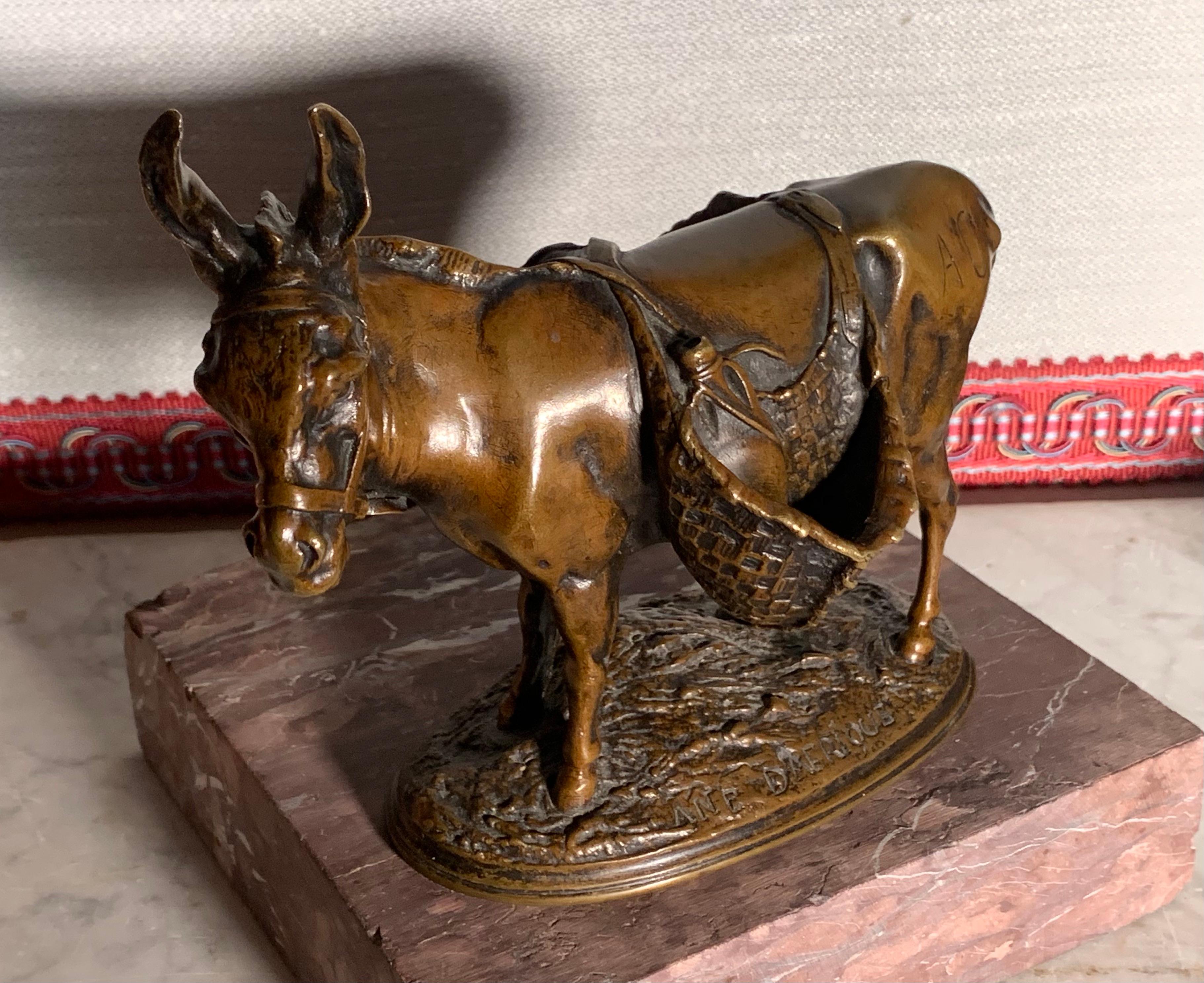Charming little bronze by the great animal sculptor Auguste-Nicolas Cain, signed A.Cain on the side, inscribed Ane d’Afrique (Donkey from Africa)  and Susse Fres  on the terrace. The donkey is represented loaded with its woven baskets in a vivid