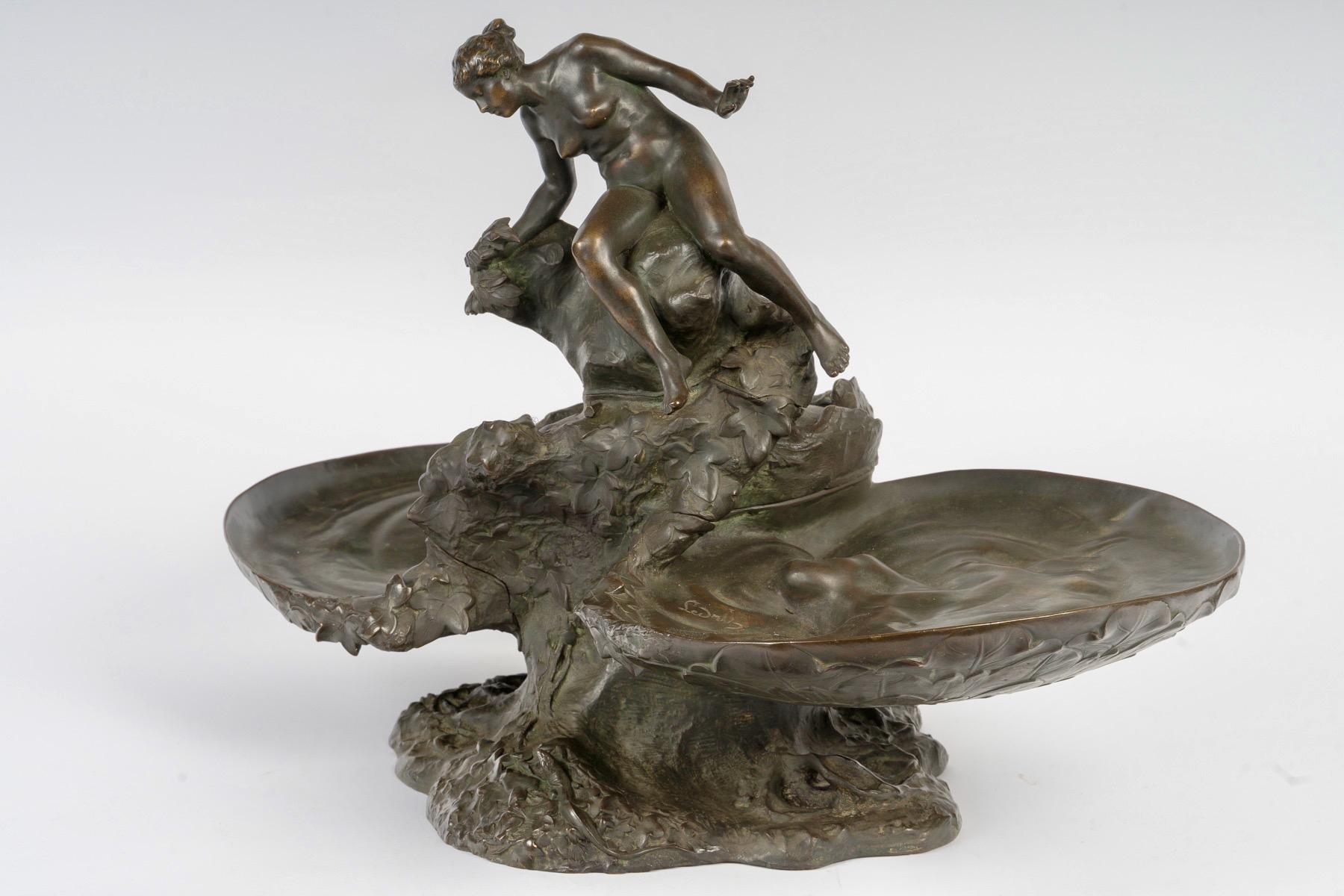 Auguste Ledru (French, 1860-1902)  Naïade Bronze Centerpiece circa 1895
Figural bronze Centerpiece 
Representing a nude woman resting on a rock and surmounting two trays designed as shells
Signed 