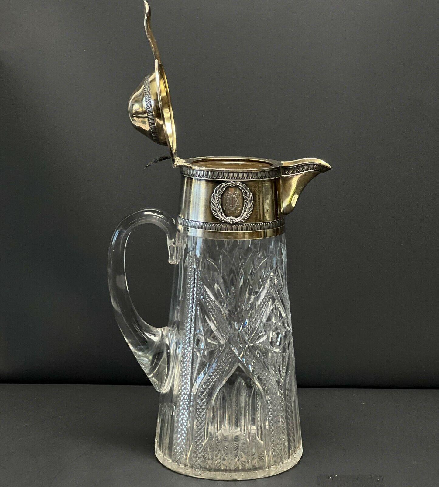 Auguste Leroy & Cie France Gilt 950 silver mounted cut glass Pitcher, circa 1920.

Cut glass star and fan design to the body. Gilt silver mounts with raised laurel wreath decoration framing a monogram to wither side. Hinged lid with seashell form