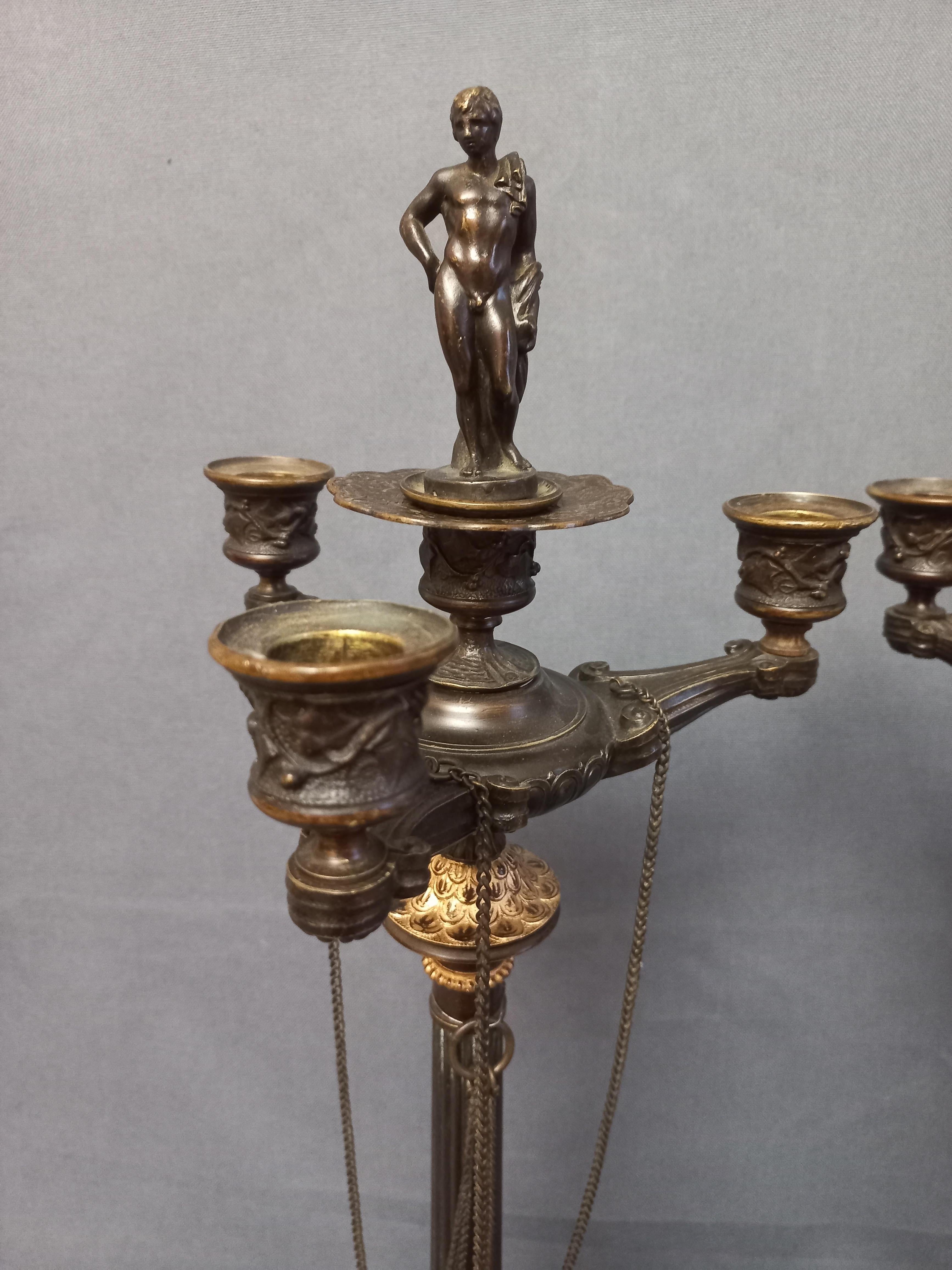 Auguste-Maximilien Delafontaine (1813-1892) Large pair of bronze candelabra with brown and gold patina.
Base with tripod feet decorated with chimeras, claw feet and foliage.
Fluted shaft with chains supporting four sconces, at the top a couple of