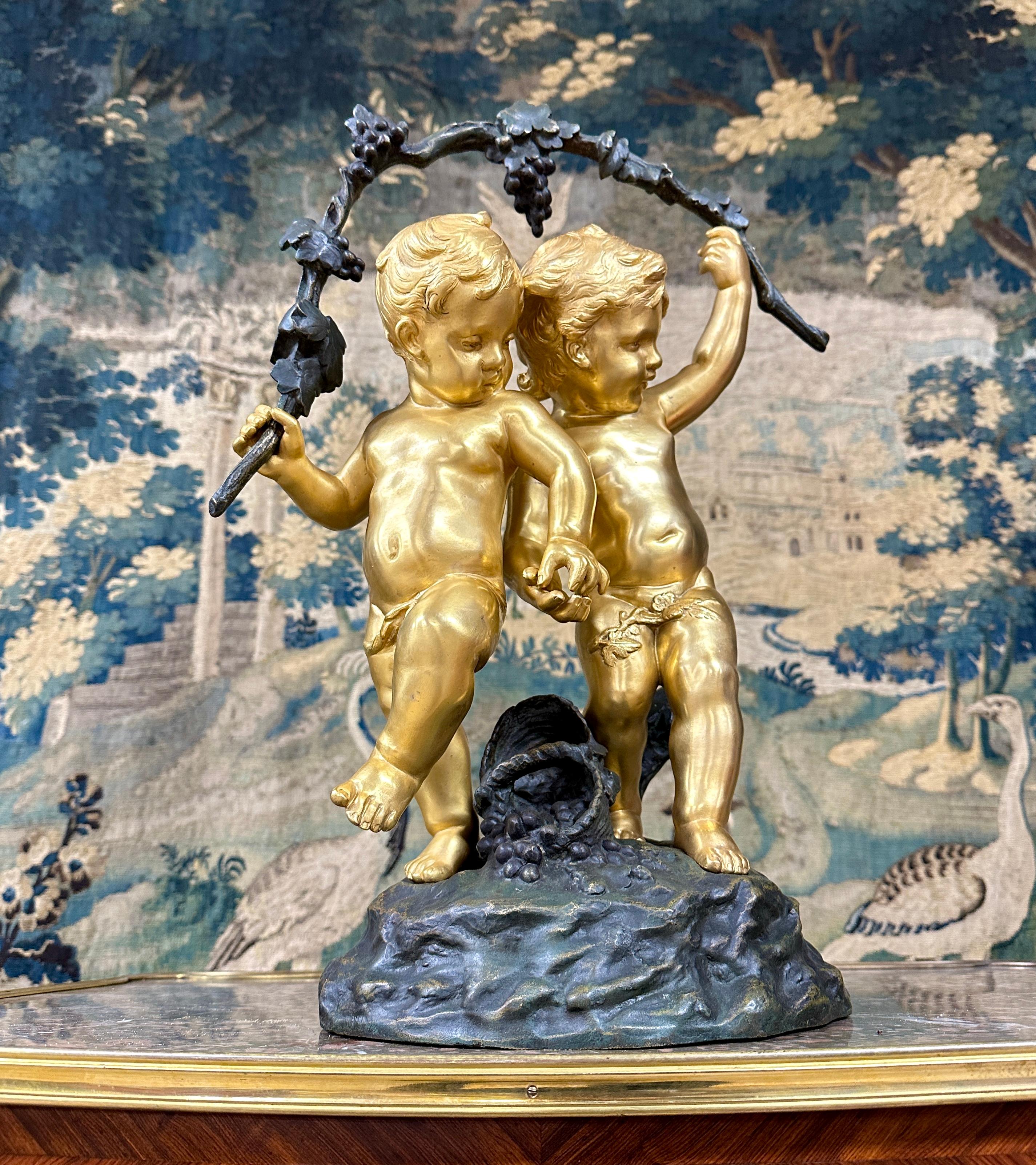 Auguste Moreau, two putti carrying bunches of grapes, shown hand in hand with a basket of grapes at their feet. Work in patinated bronze and gilded bronze signed on the terrace by 
