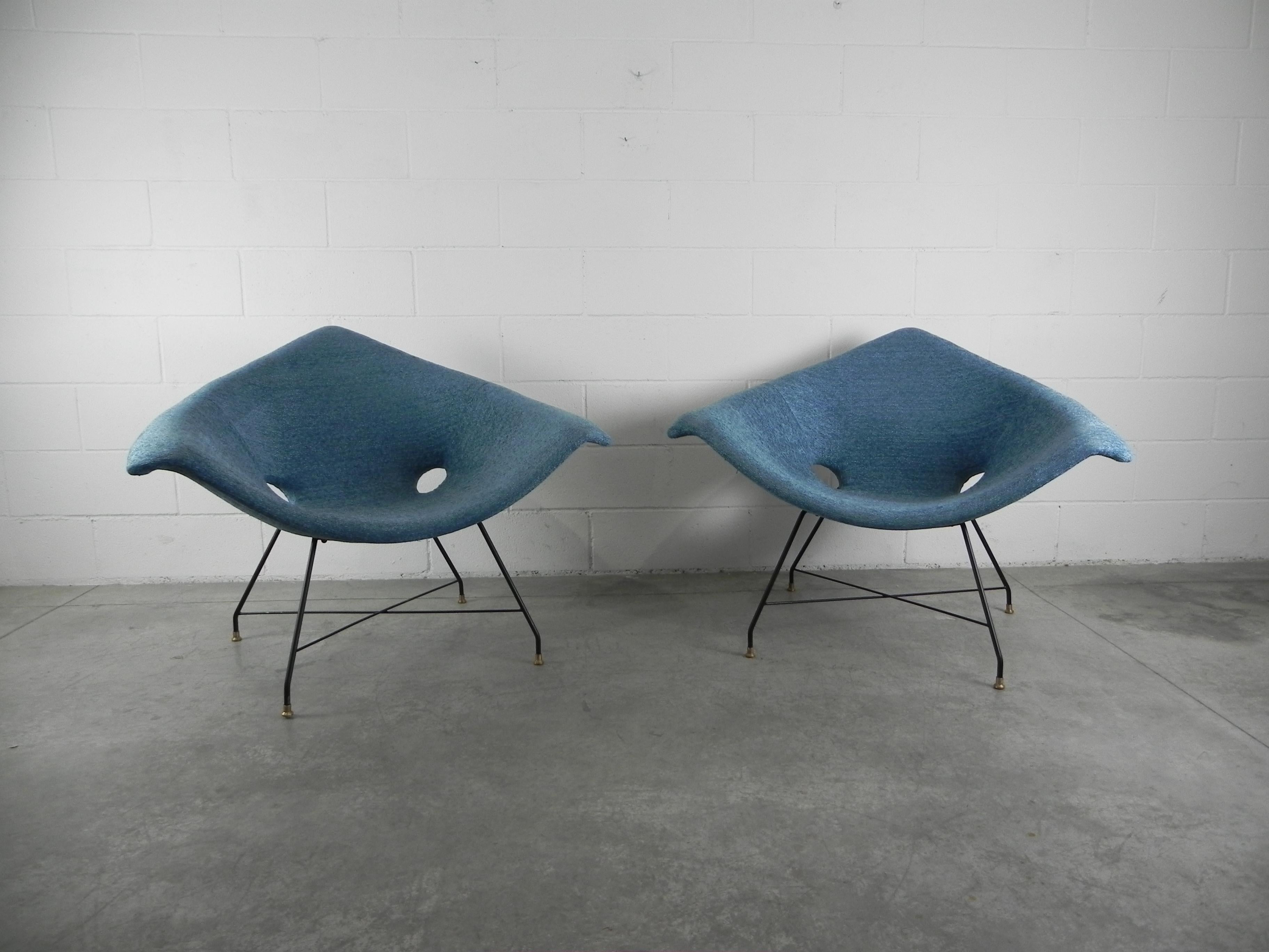 Rare pair of lounge chairs designed by Augusto Bozzi for Saporiti Italia, Italy, 1954. The chairs have a black lacquered metal base with solid brass feet and are newly upholstered. Makers label to underside.