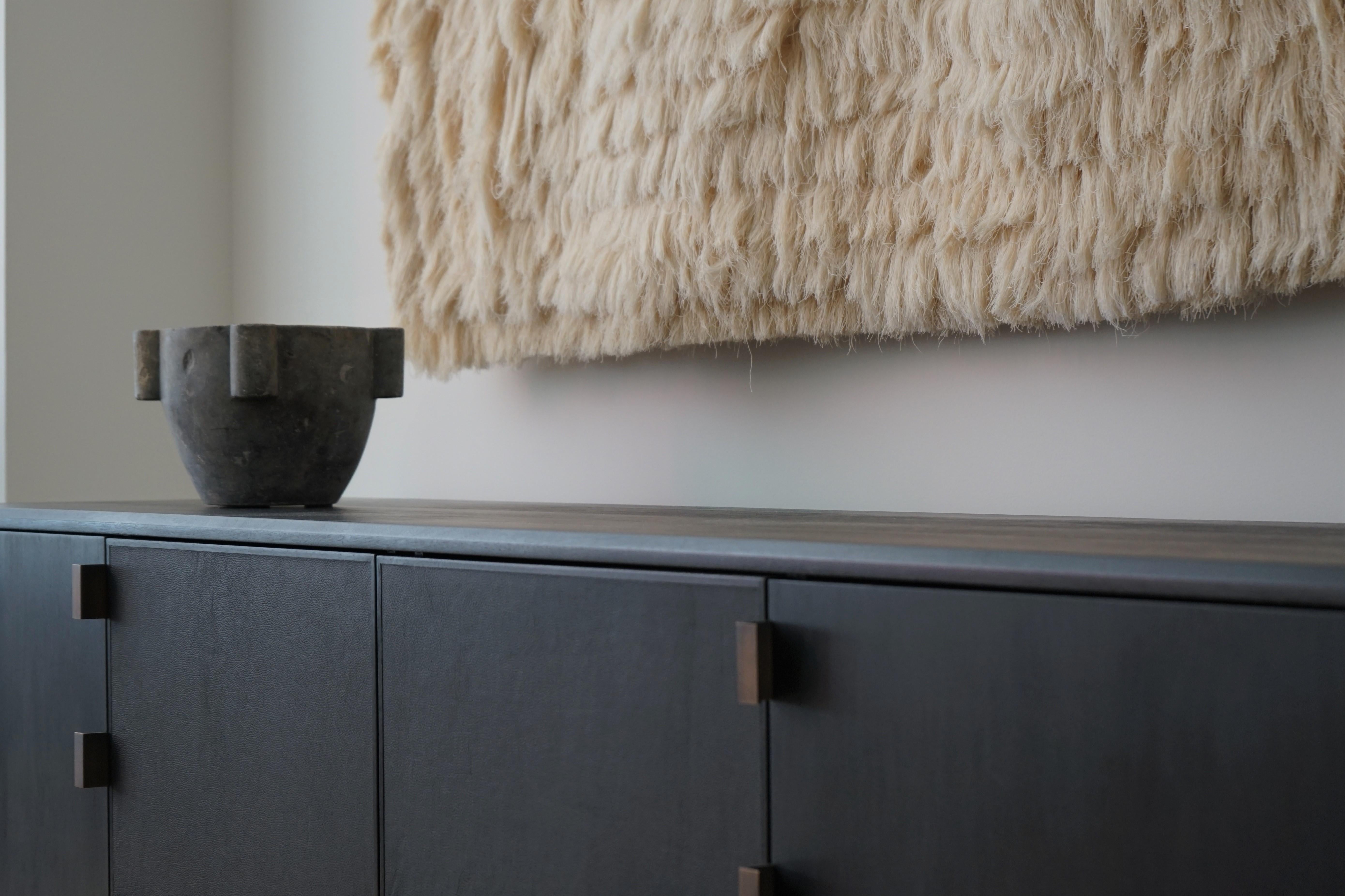 The design of the Augusto Credenza stems from the uniqueness of Mexican Brutalist architecture, itself a mix of pre-Columbian styles with 20th Century modern architecture and its European influences. The Medium size features two push-to-open, soft