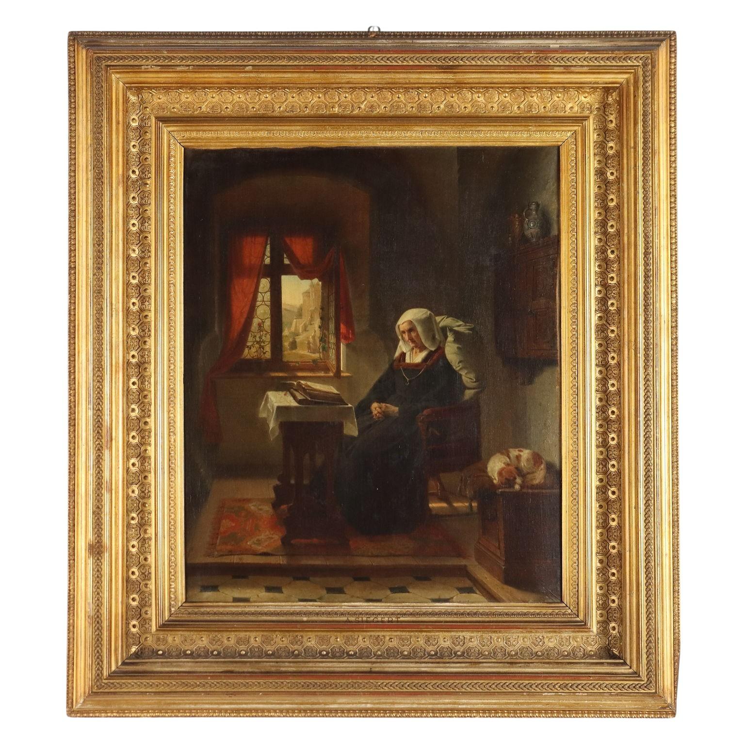 Olio su tela. Firmato in basso a destra.
In una stanza sobriamente arredata, una donna anziana siede a leggere, o forse a meditare, con il libro appoggiato sul tavolino sotto la finestra, mente il cagnolino dorme acciambellato suu na panca alla
