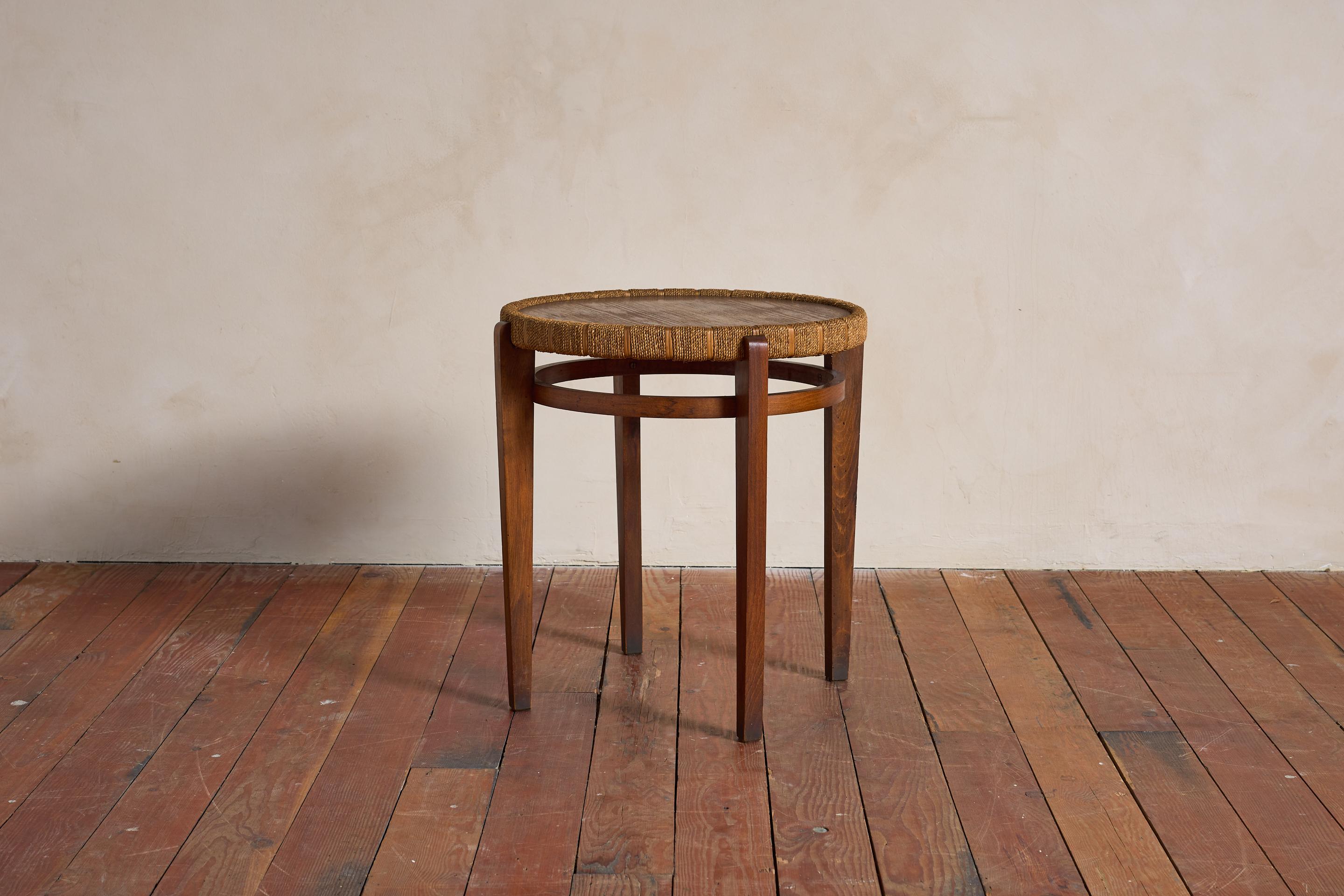 Circular Italian side table by Augusto Romano, Italy, 1950s

Woven rush along the trim with wonderful patina to wood. 

Two Available - slightly different patina

