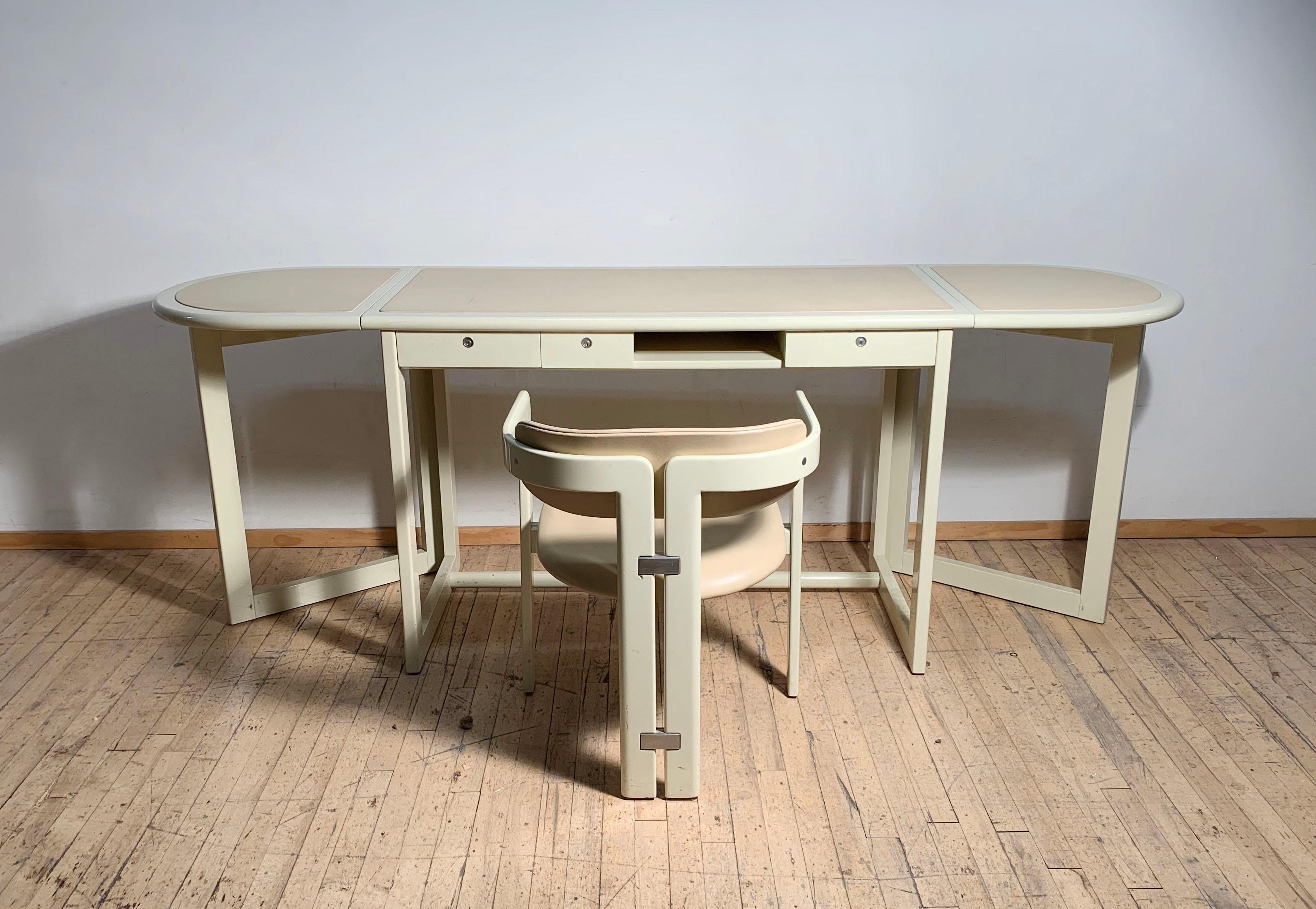 Uncommon desk form to come across. Original ivory white lacquer over wood with leather insets. Pozzi label attached. 3 drawers with locks (no keys included-should be easy to replace these if desired) more pictures available.

The desk space with