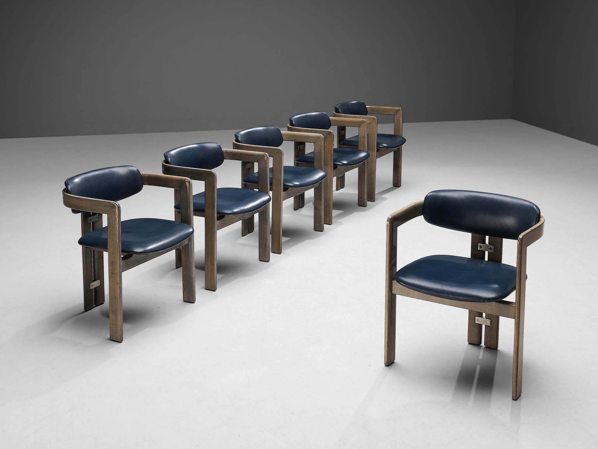 Augusto Savini for Pozzi, set of six 'Pamplona' dining chairs, oak, blue leather upholstery, aluminum, Italy, 1965.

Set of six armchairs in walnut and blue leather upholstery. A characteristic design; simplistic yet very strong in lines and