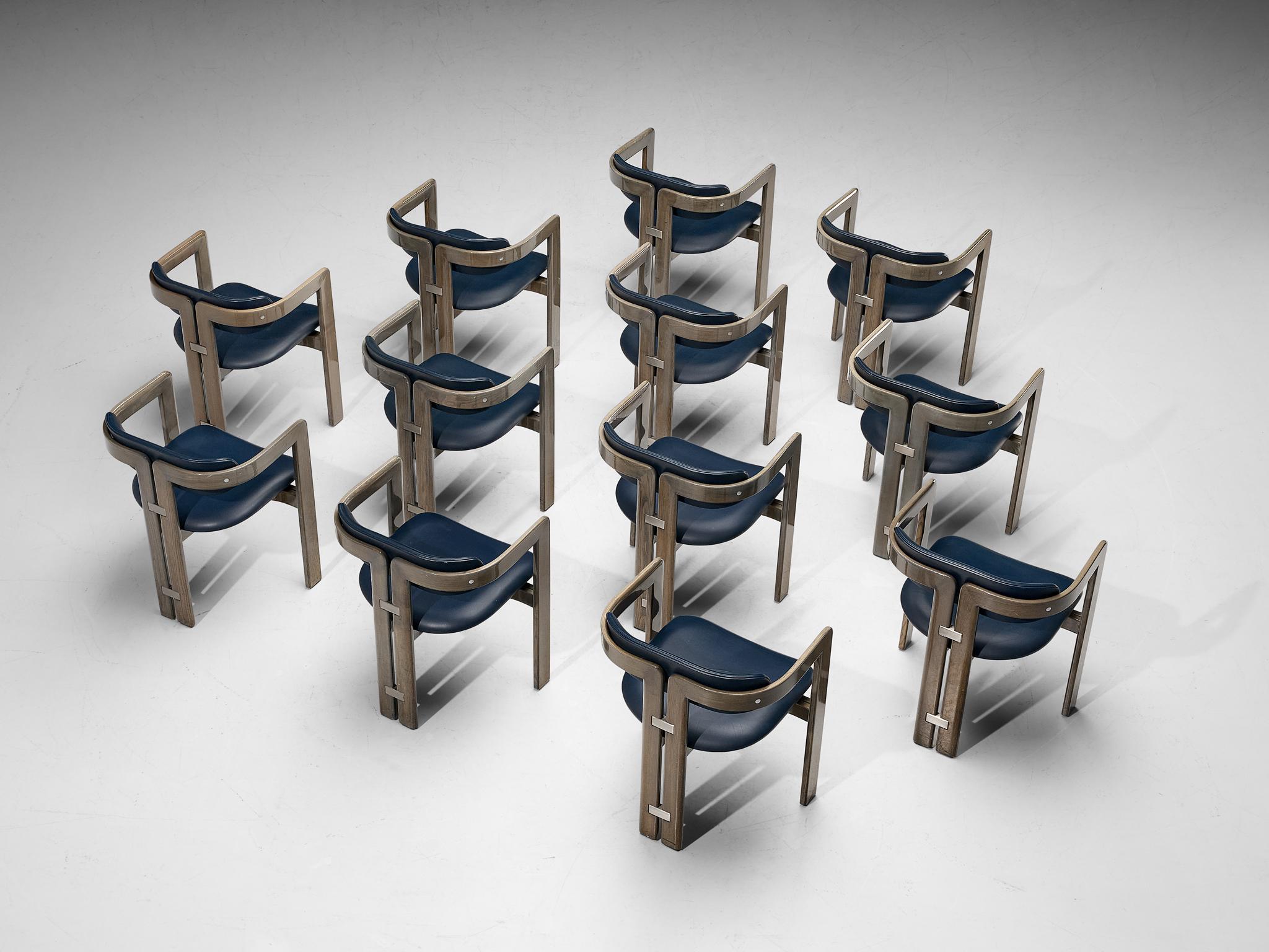 Augusto Savini for Pozzi, set of twelve 'Pamplona' dining chairs, oak, blue leather upholstery, aluminum, Italy, 1965.

Set of twelve armchairs in walnut and bue leather upholstery. A characteristic design; simplistic yet very strong in lines and