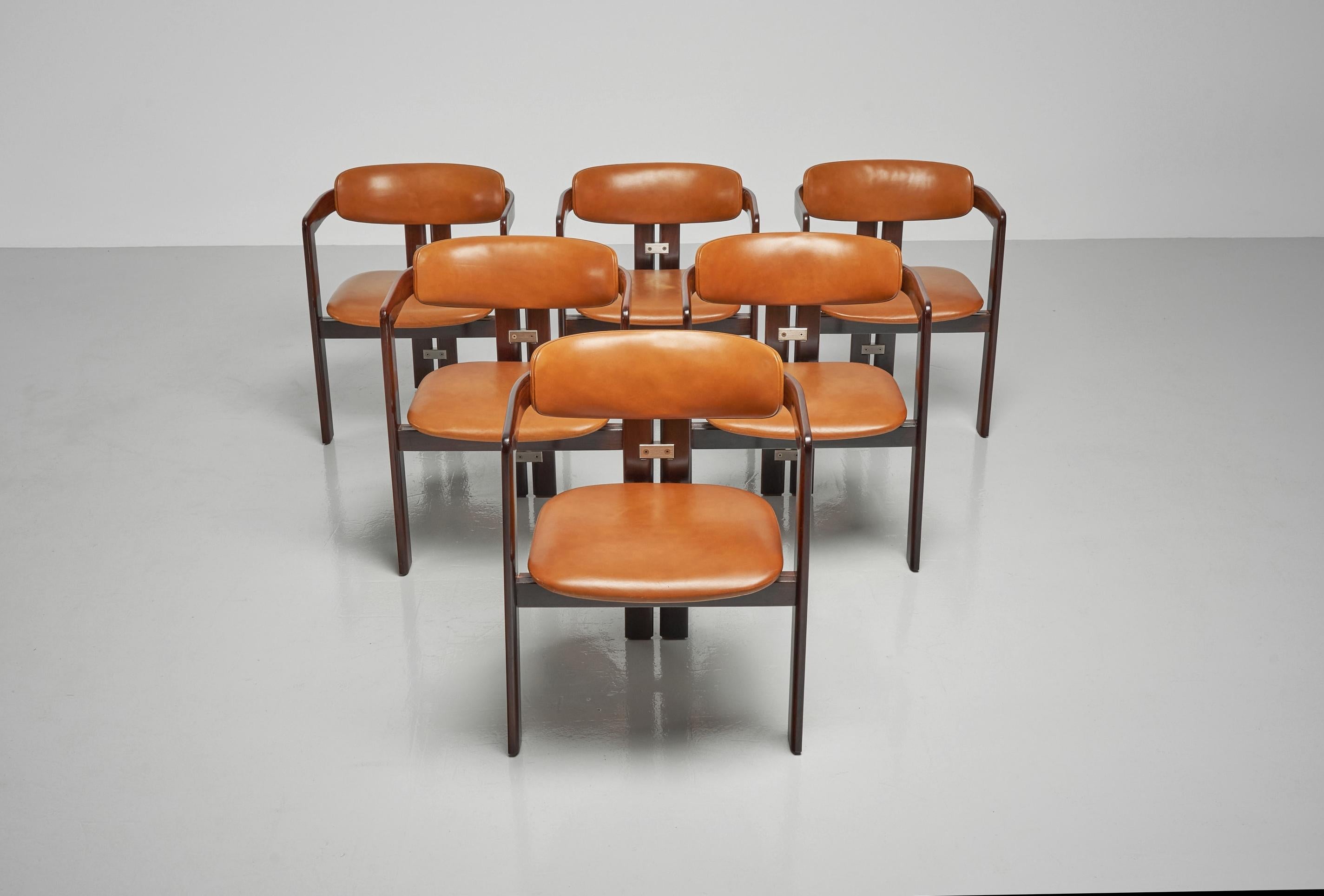 A fantastic, well-preserved set of 6 so called 'Pamplona' chairs designed by Augusto Savini and manufactured by Pozzi, Italy 1965. These utterly comfortable dining chairs have a solid jatoba structure which has the appearance of rosewood. It has