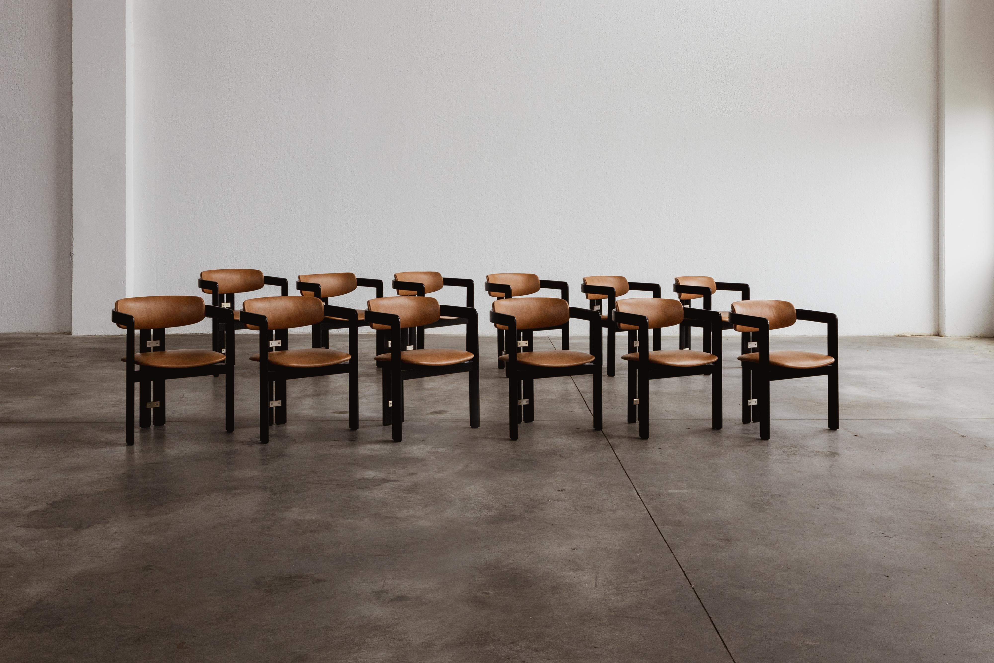 Augusto Savini “Pamplona” dining chairs for Pozzi, black framework and ranch leather, Italy, 1965, set of twelve.

In the realm of Italian craftsmanship, the Pamplona chairs by Augusto Savini for Pozzi stand as a symbol of architectural elegance.