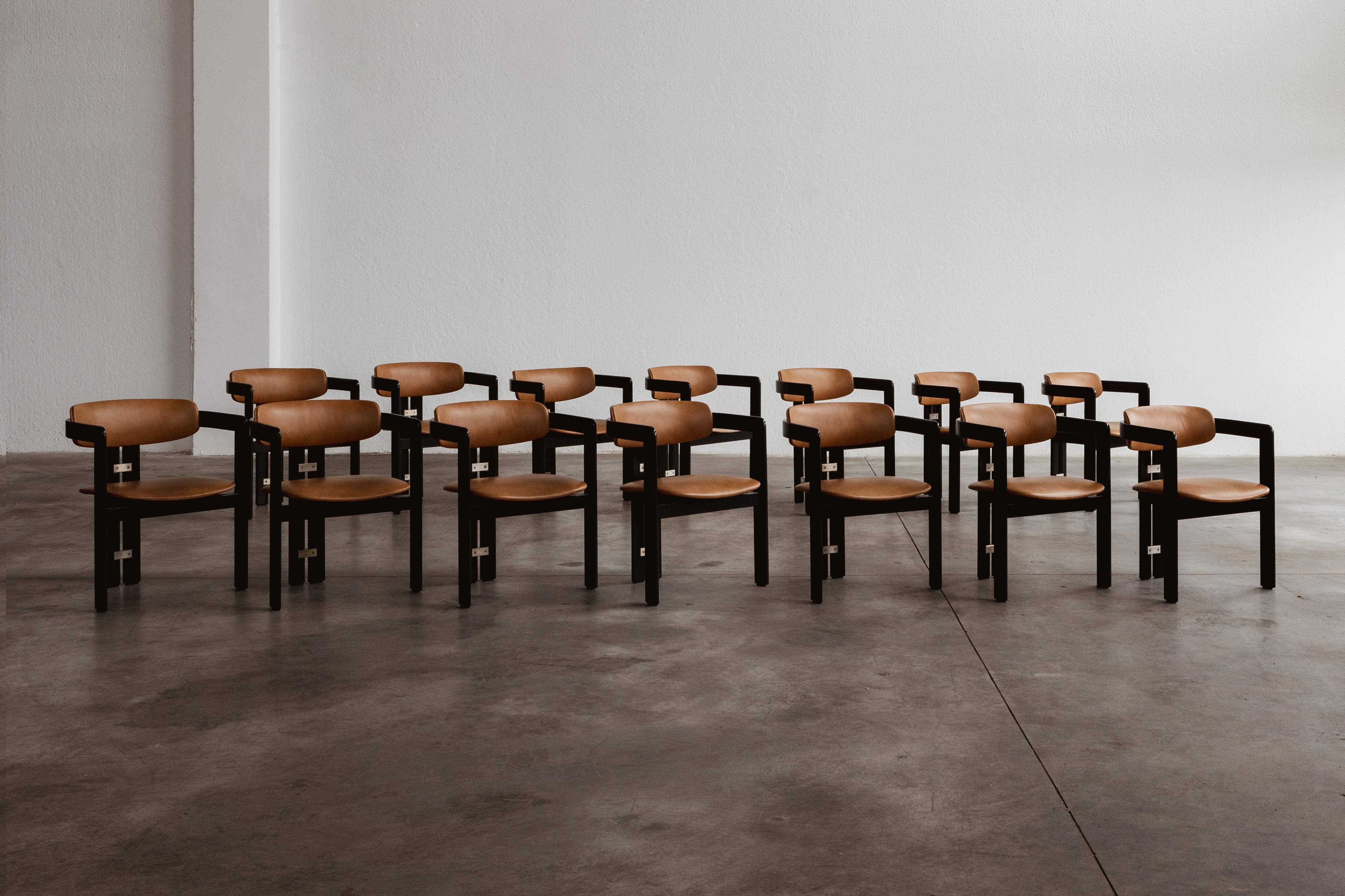Augusto Savini “Pamplona” dining chairs for Pozzi, black framework and ranch leather, Italy, 1965, set of fourteen.

In the realm of Italian craftsmanship, the Pamplona chairs by Augusto Savini for Pozzi stand as a symbol of architectural elegance.