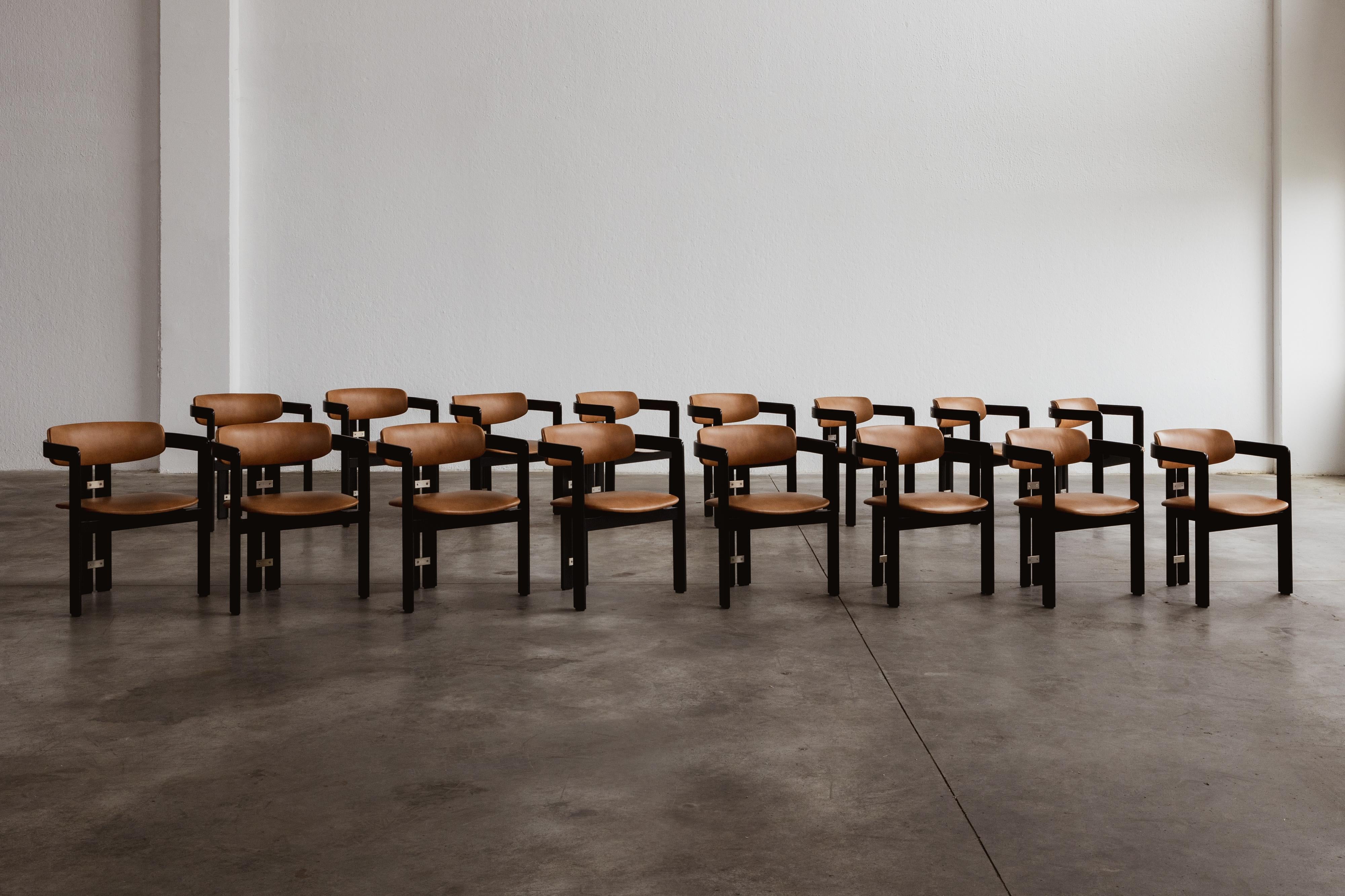 Augusto Savini “Pamplona” dining chairs for Pozzi, black framework and ranch leather, Italy, 1965, set of sixteen.

In the realm of Italian craftsmanship, the Pamplona chairs by Augusto Savini for Pozzi stand as a symbol of architectural elegance.