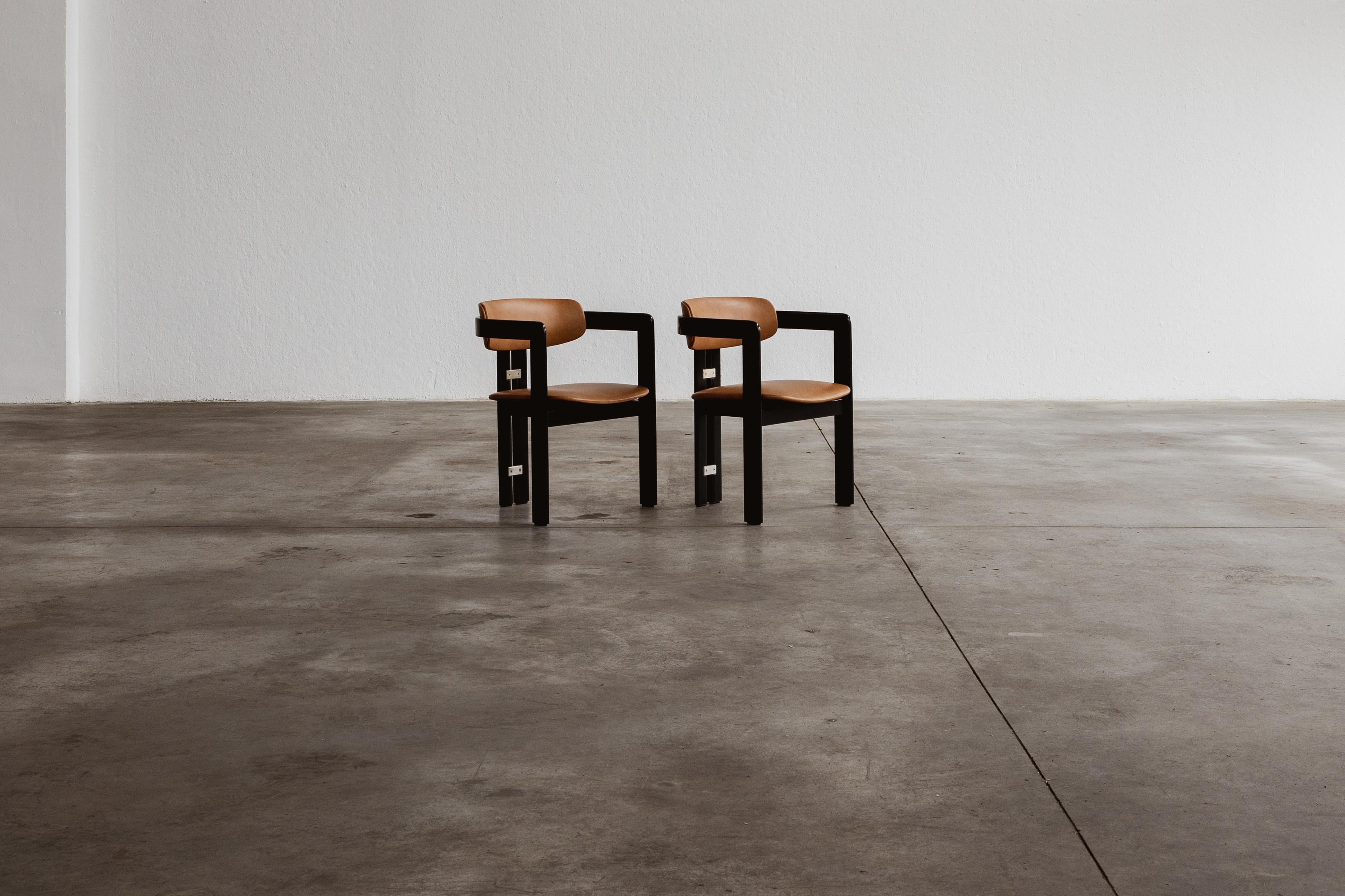 Augusto Savini “Pamplona” dining chairs for Pozzi, black framework and ranch leather, Italy, 1965, set of two.

In the realm of Italian craftsmanship, the Pamplona chairs by Augusto Savini for Pozzi stand as a symbol of architectural elegance.