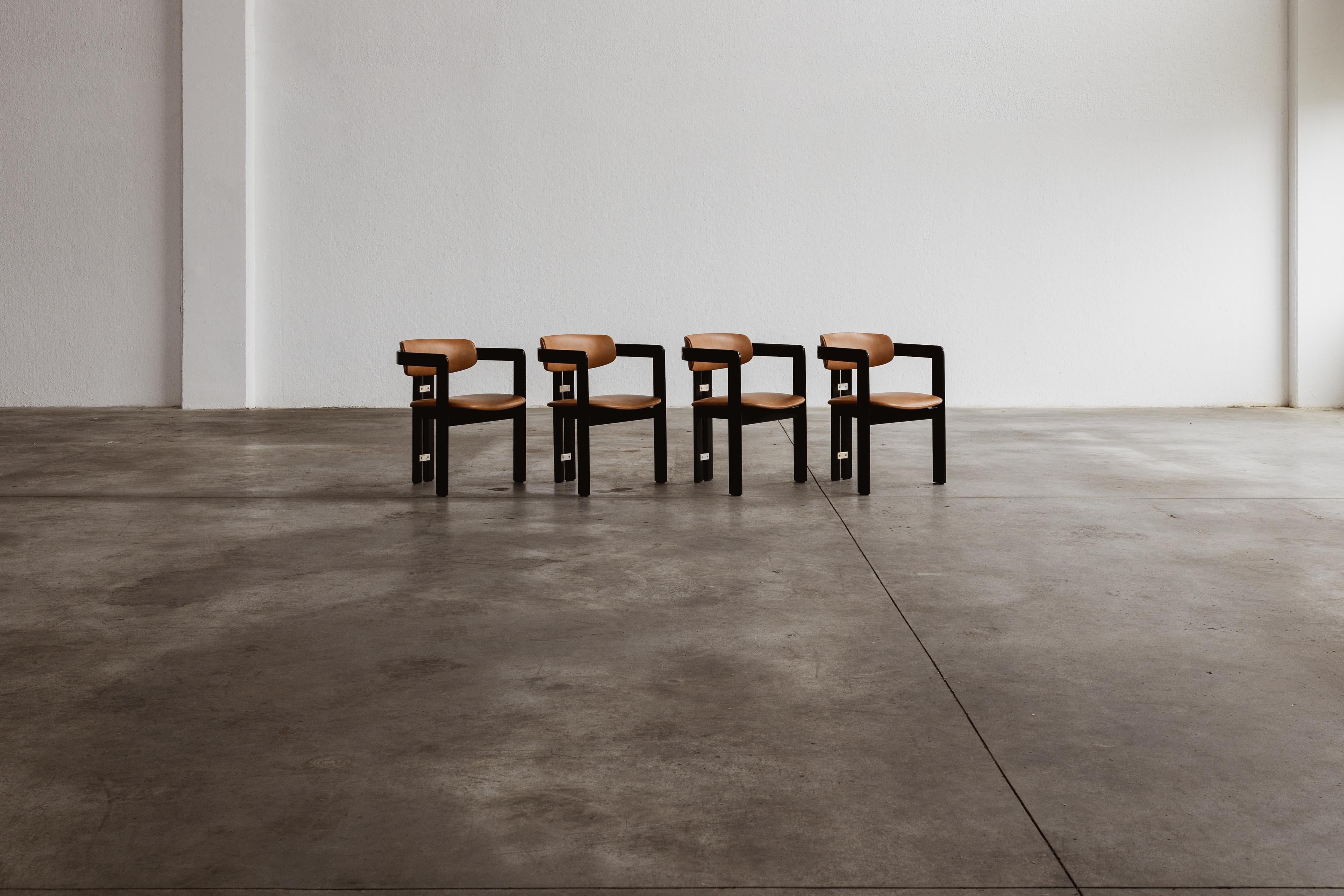 Augusto Savini “Pamplona” dining chairs for Pozzi, black framework and ranch leather, Italy, 1965, set of four.

In the realm of Italian craftsmanship, the Pamplona chairs by Augusto Savini for Pozzi stand as a symbol of architectural elegance.