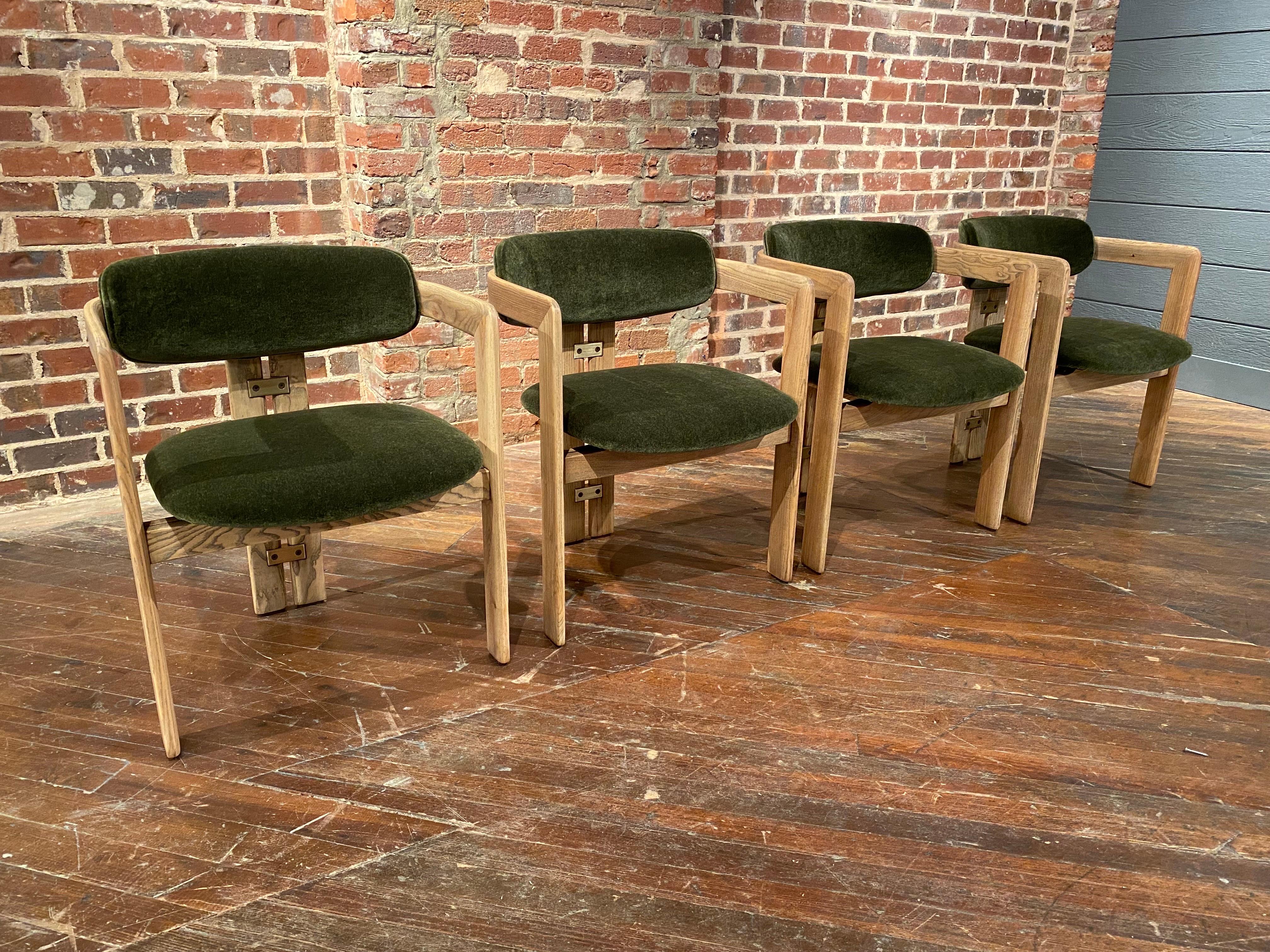An incredible set of four dining chairs by Augusto Savini.  Pamplona dining chairs produced by Pozzi in Italy circa 1960.  These have solid ash frames with new mohair velvet upholstery.  A striking minimal design newly refinished, updated   and