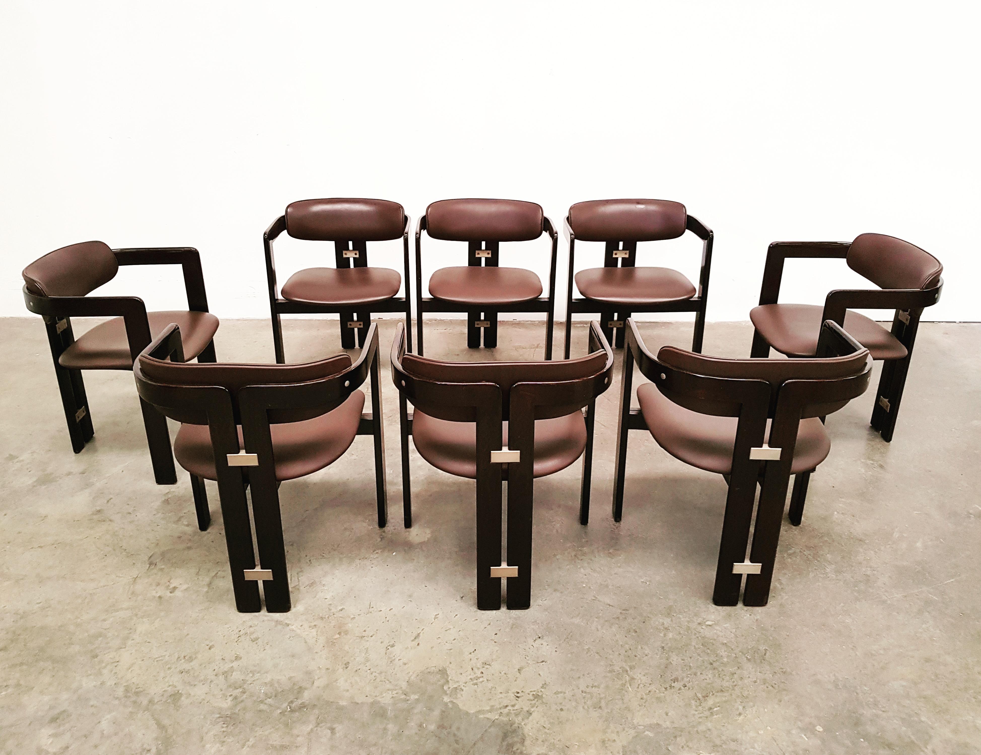 Augusto Savini, set of sixteen 'Pamplona' dining room chairs, stained ashwood and turquoise suede, by for Pozzi, Italy, 1965. 

Mahogany bentwood frame and brown leather upholstery. 
The aluminum elements on the back emphasize the tight and