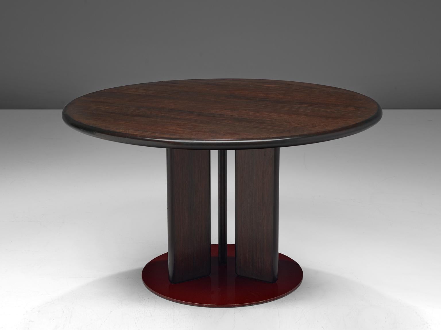 Augusto Savini, dining table, wood, Italy, 1970s.

Round dining table designed by Augusto Savini. The able is made of darkened wood and consists of three legs, attached to a red lacquered foot. The table can function as a dining table or a center