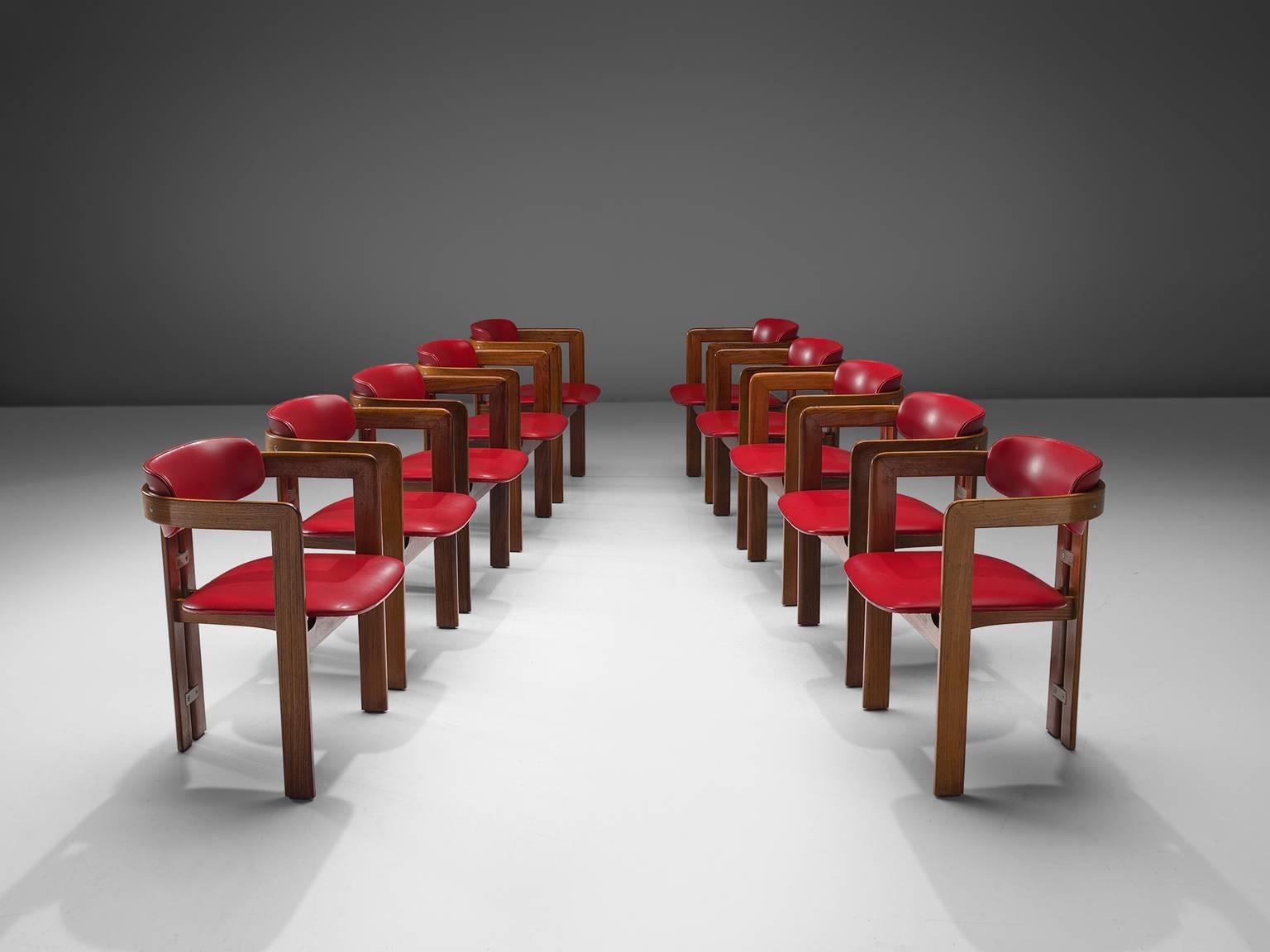 Set of ten 'Pamplona' dining room chairs, in wood and red leatherette by Augusto Savini for Pozzi, Italy, 1965. 

Set of ten armchairs in walnut and red leatherette upholstery. A characteristic design; simplistic yet very strong in lines and