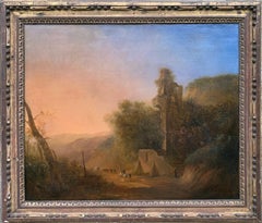 Romantic sunset landscape with ruins and travelers