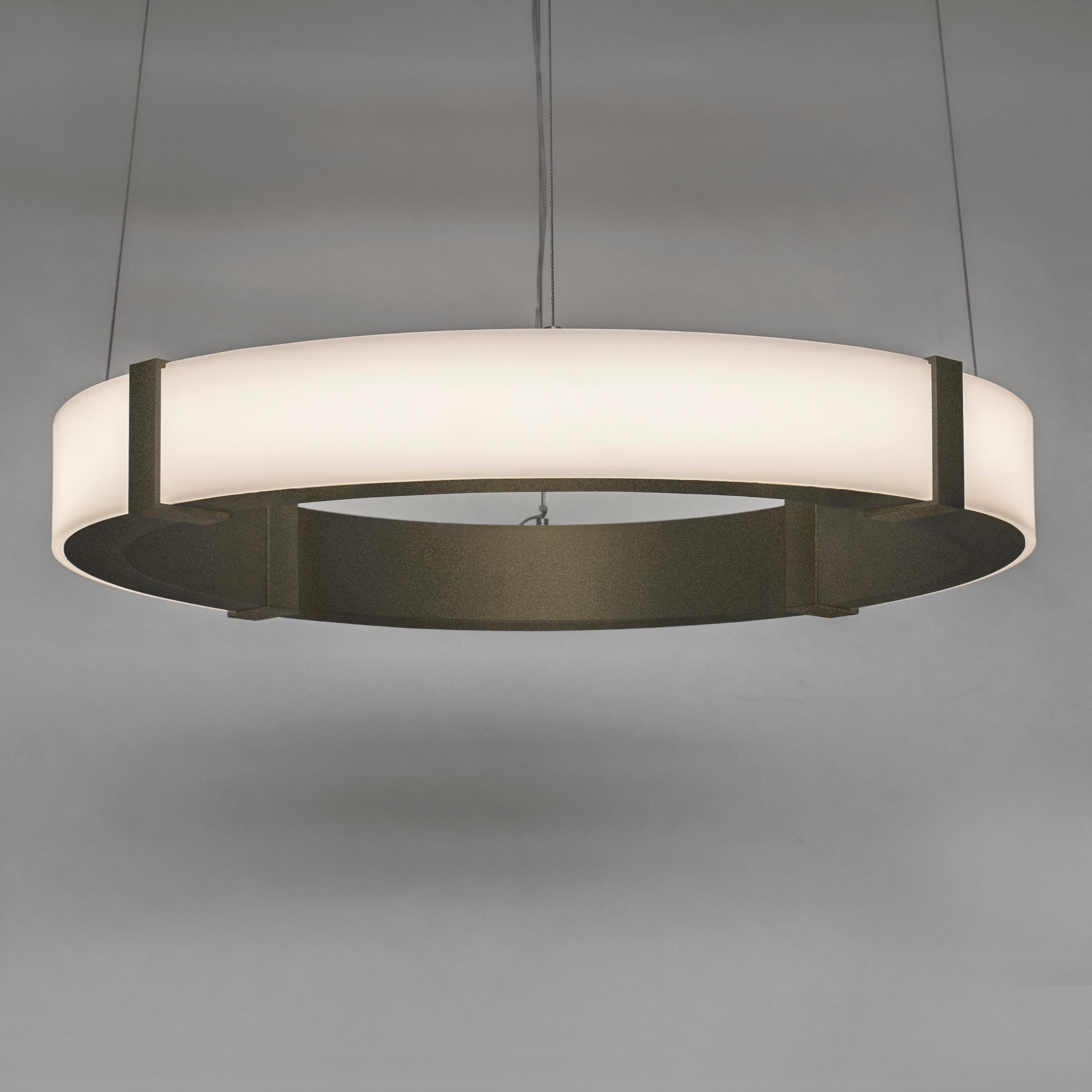 The Aura Alto Inverso pendant emits an elegant glow that is diffused by a minimal satin white acrylic outer ring. The inner ring is composed of cold-rolled steel and can be finished in plated or powder coat options. The Aura Alto Inverso Pendant
