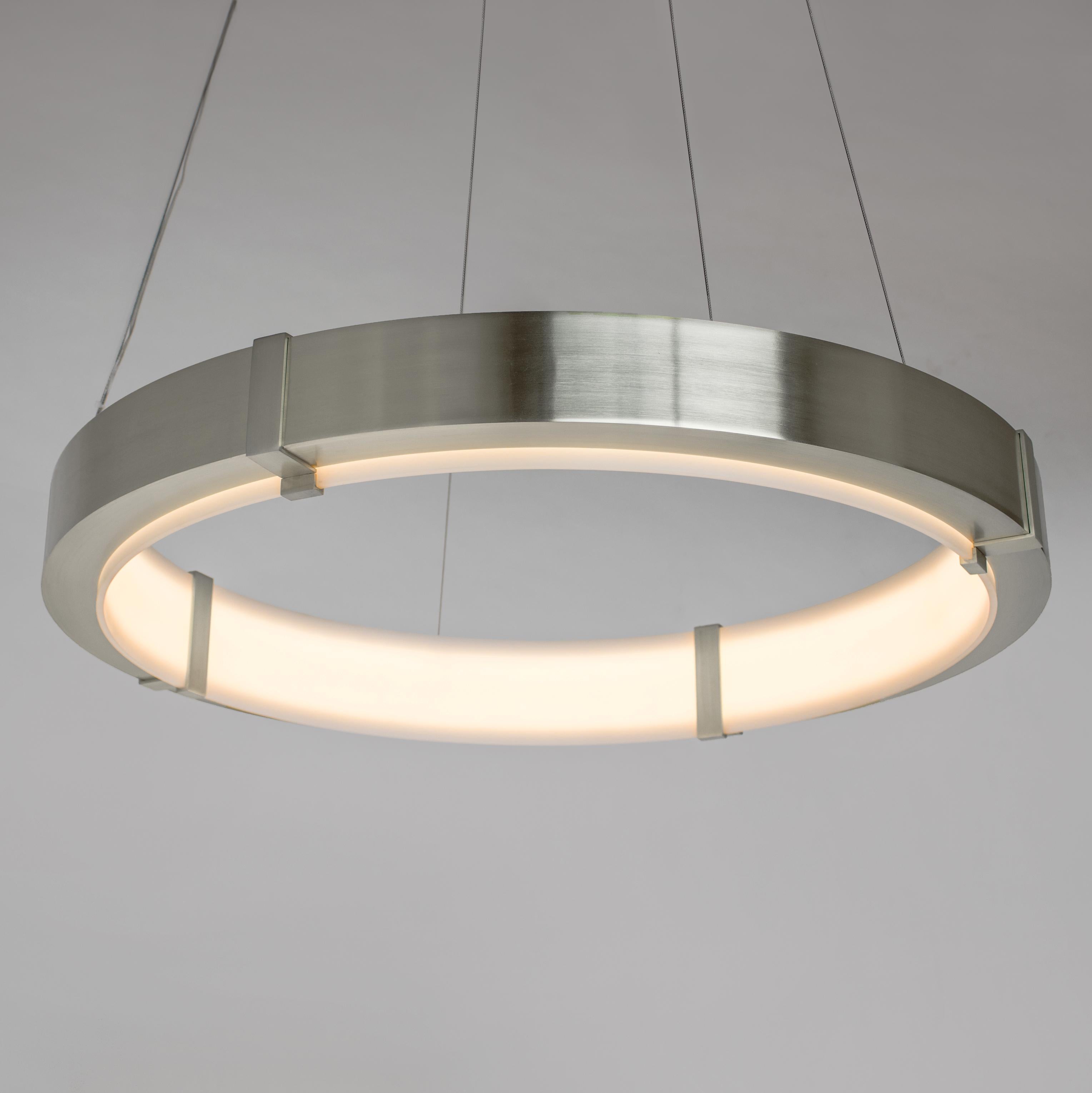 The Aura Pendant emits an elegant glow that is diffused by a satin white acrylic inner ring. The outer ring is composed of cold-rolled steel and is finished with a plated or powder coat finish. The Aura Pendant works beautifully in larger