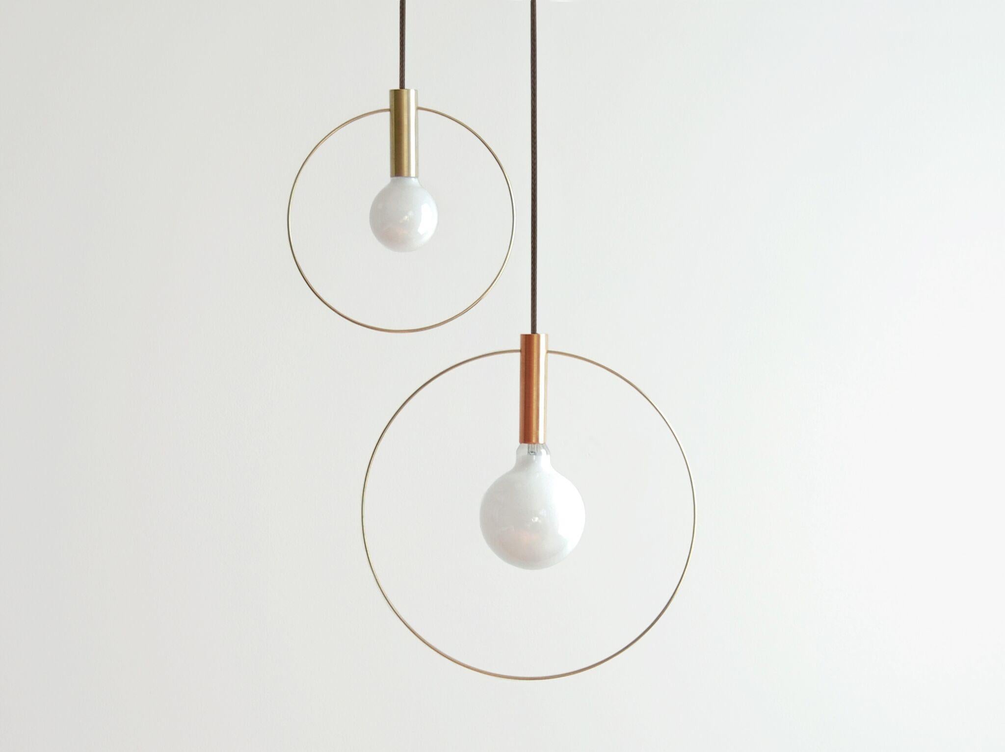 Light pared down into its two elemental ingredients: the source (the bulb) and its illumination (highlighted by a ring) The resulting Aura pendant lights are simple and versatile. This 5 piece row configuration ties a mix of 5 Aura pendants to one