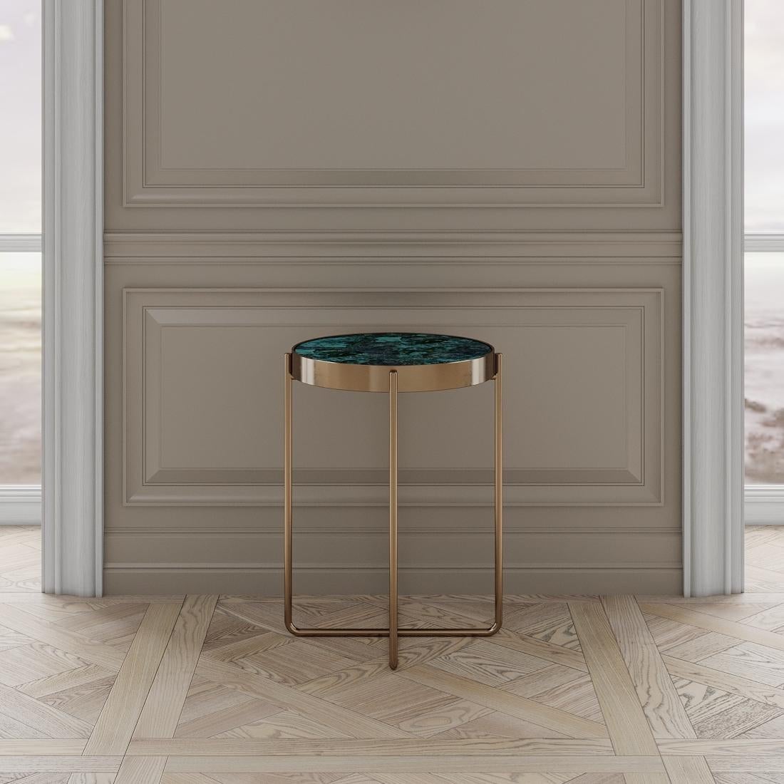 The Aura side table is designed by Emél & Browne in the minimalist and contemporary style and custom made in Italy by skilled artisans. The Aura side table instills the essence of dusk on the horizon. Agate Apatite Coroldite, mined in Italy shimmers