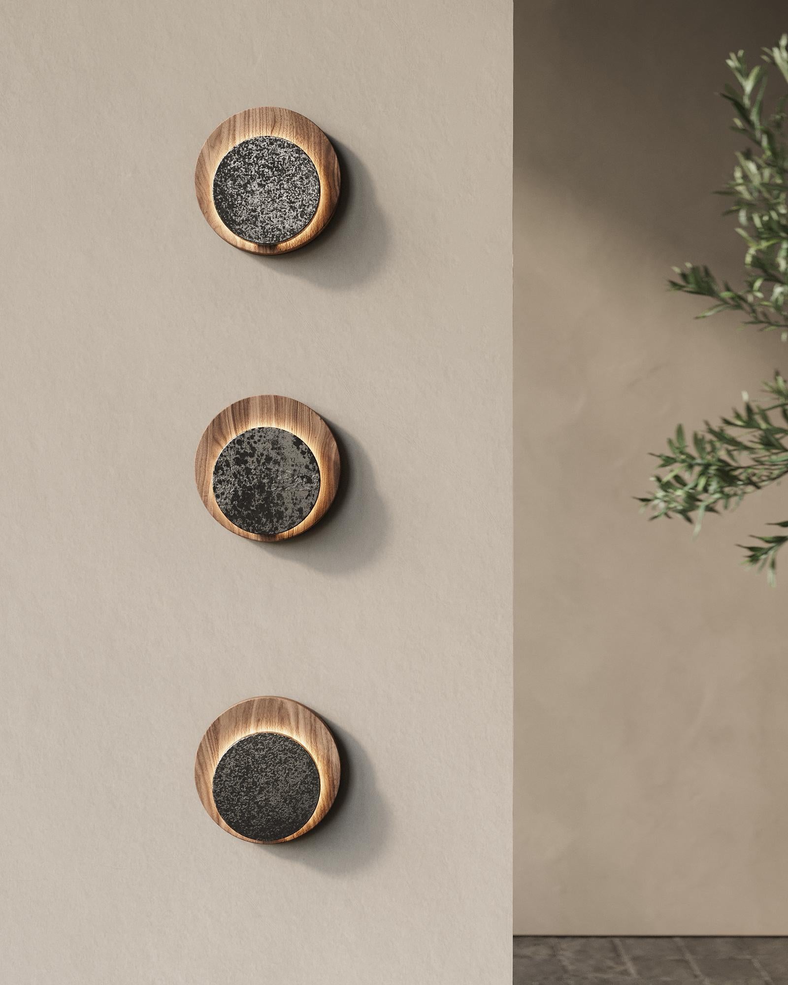 AURA WALL 14 consists of a solid walnut wood circle that contrasts with the monochromatic tones of the porcelainized steel piece.

Iluminant: Incl. 4 W G9 LED 402 lm, 120 V ~ 60 Hz 0.04 A
2700 K / Not Dimmable