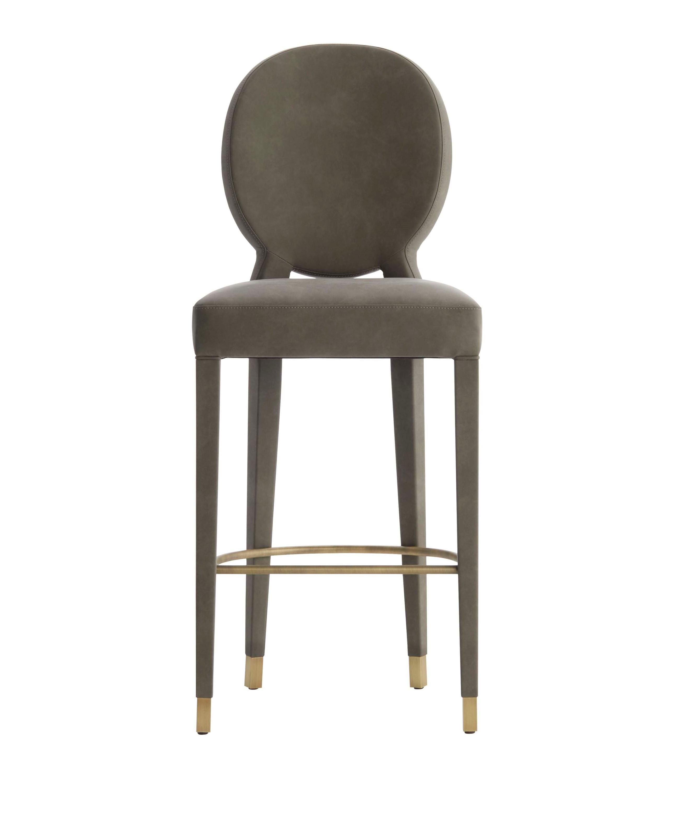 AUREA is a high stool with sophisticated design, very comfortable and well balanced piece.‎‎ The back is highlighted by a delicated quilting in diamond's shape and the lined legs settles on antique brass tips.‎‎ Available in fabric,