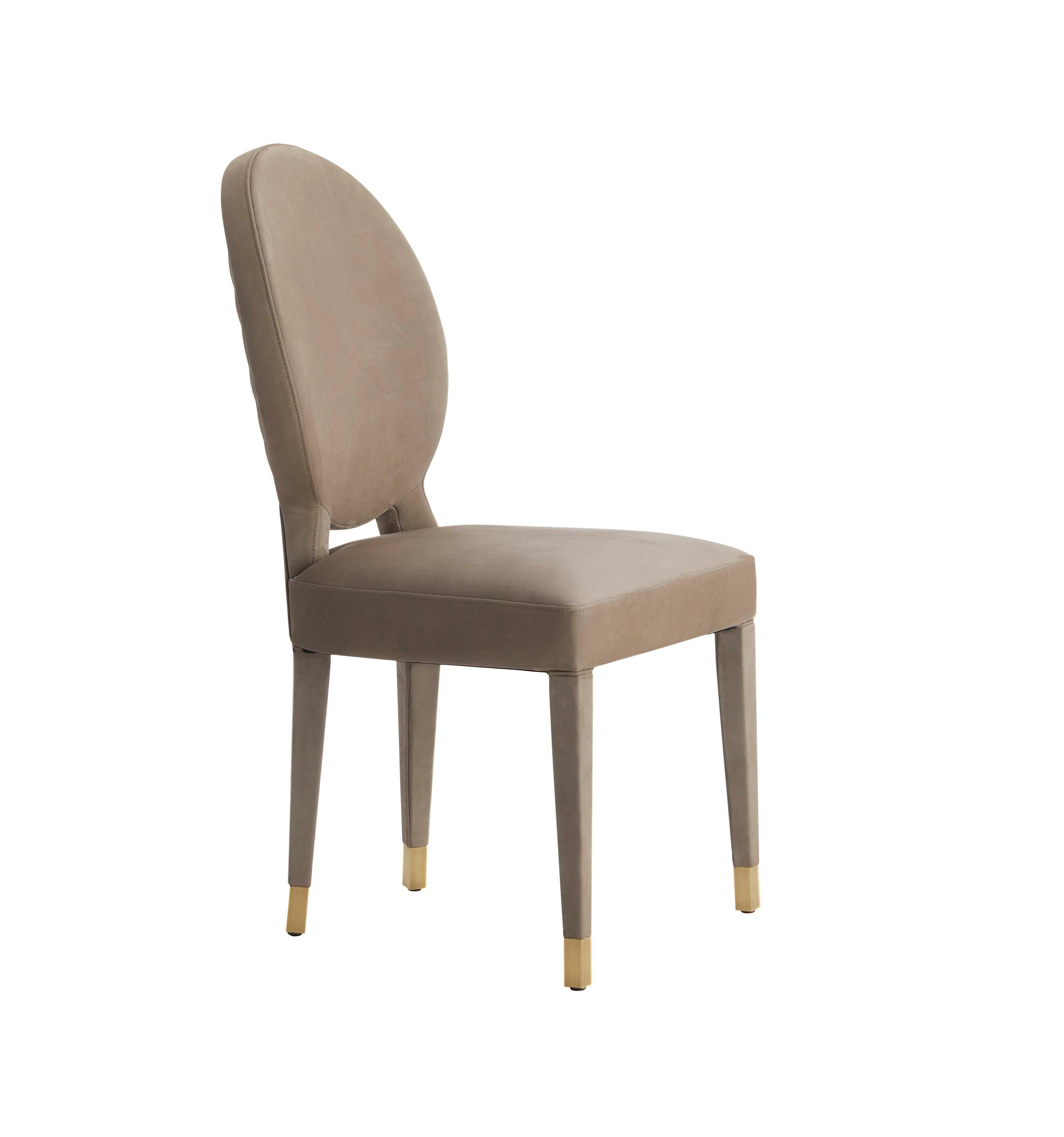 AUREA is a dining chair with sophisticated design, very comfortable and well balanced piece.‎‎ The back is highlighted by a delicated quilting in diamond's shape and the lined legs settles on antique brass tips.‎‎ Also avalable in fabric,