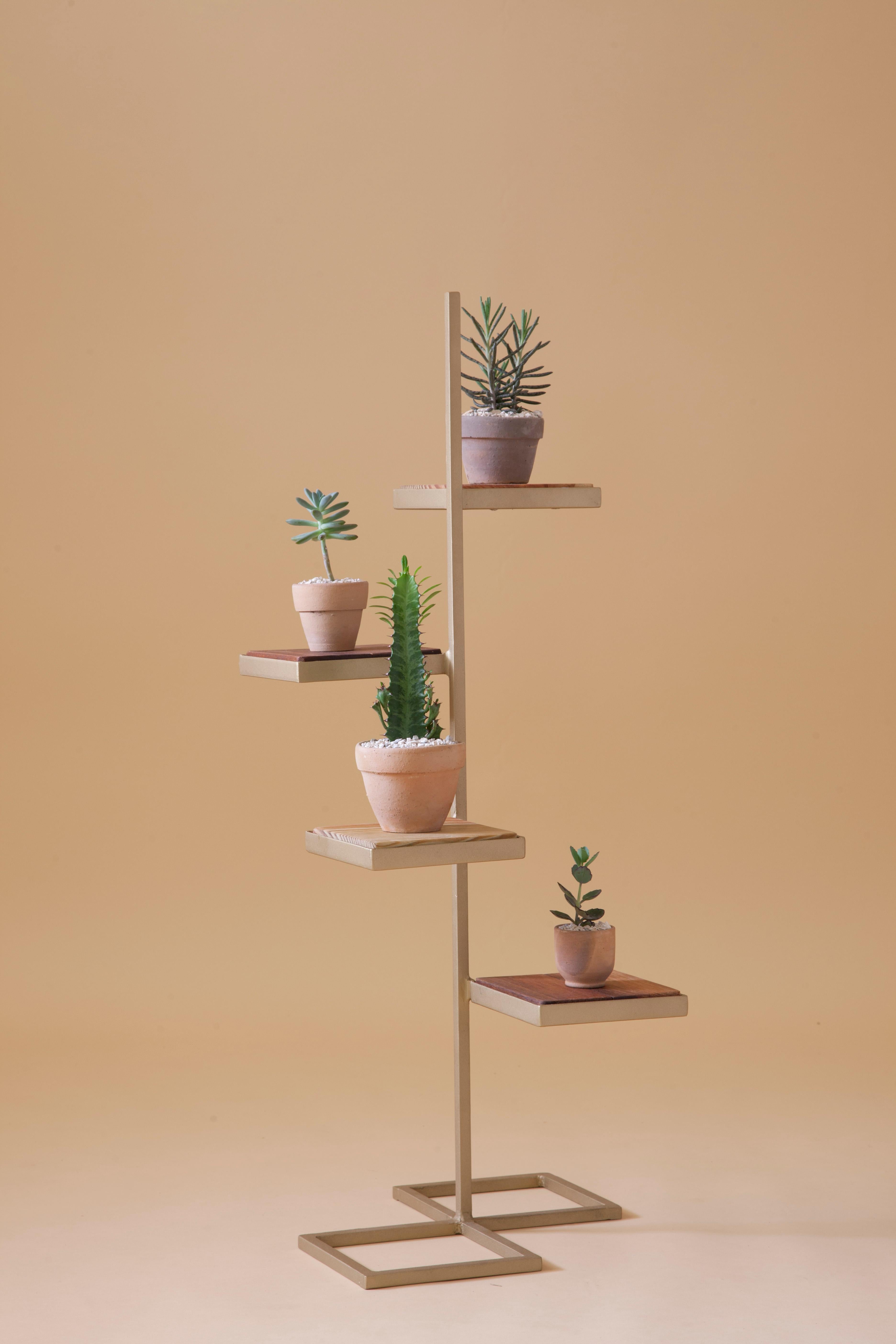 Aurea plant stand 3 by Sofia Alvarado
Limited edition 1 of 10 (one in stock)
Materials: Metal & woods / Golden, white or black.
Dimensions: 86cm (H) x 32cm (W) x 32cm (D)

FI is an ornamental artist who embodies the creative revelation of the