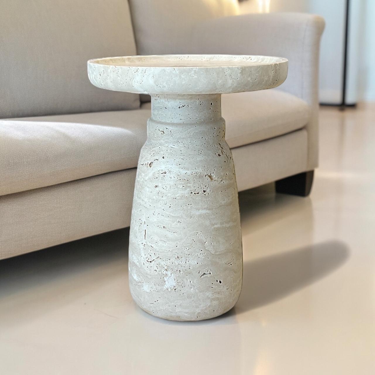  ‘Aurea’ Side Table by HAAND, crafted from premium beige travertine stone. This exquisite piece measures 13.8 inches in diameter and 18.5 inches in height, with a substantial weight of 80 lbs.

The Aurea Side Table is a testament to superior design
