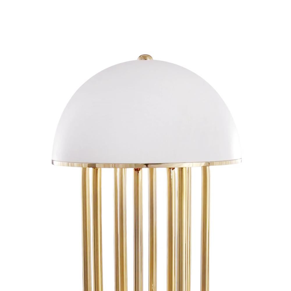 Table lamp Aurea with solid brass structure in polished finish and 
with white aluminium base and shade. Brass parts are swiveled.
With 3 bulbs, lamp holder type G9 LED bulbs, 4 Watts, not dimmable,
bulbs not included.
