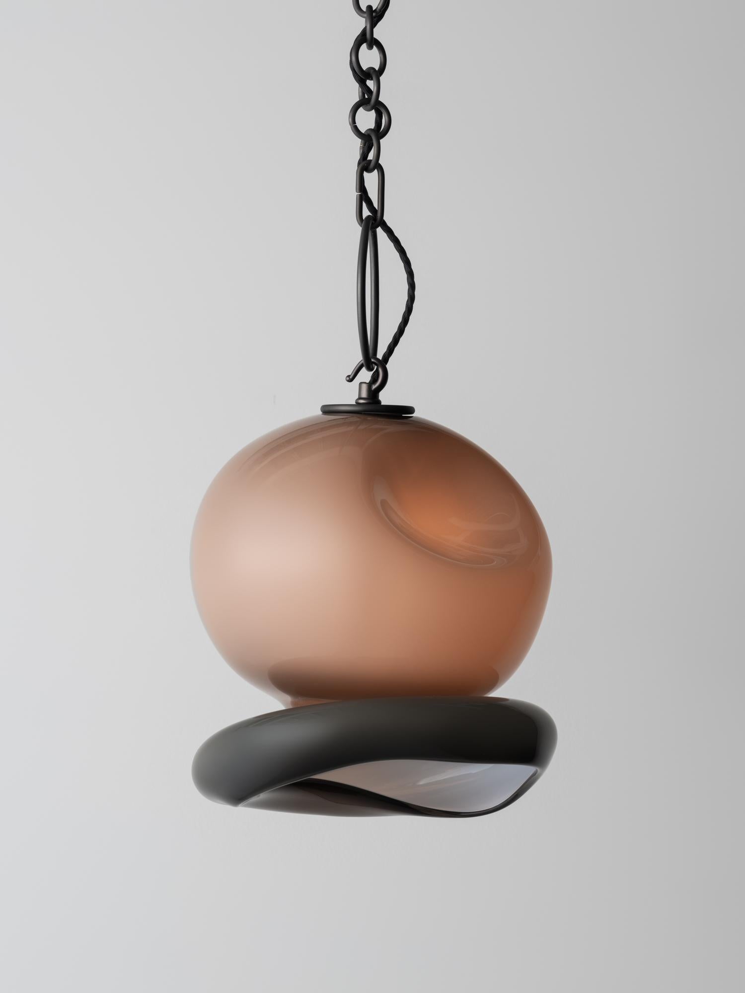 The Aurelia Pendant is reminiscent of moon jellyfish and is rendered in layered handblown glass with a delicate brass chain. It is part of the Marea Collection - an exploration of organic forms inspired by marine life and underwater seascapes. Marea