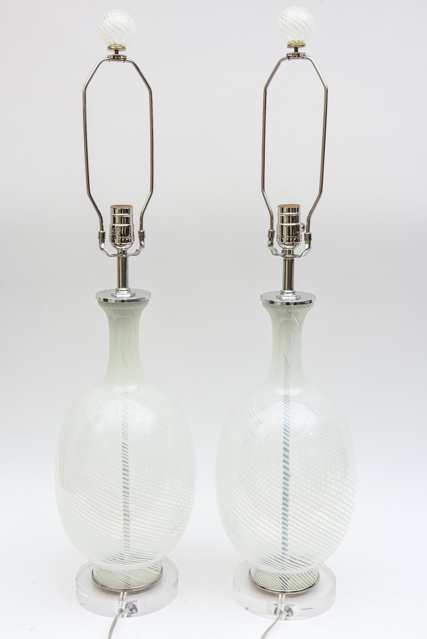 These pair of vintage Italian Murano Aureliano Toso white swirled glass lamps have chrome appointments and the original swirled glass fabulous Murano balls as the finials. They have been rewired and cleaned. The glass finials are 2.5 inches H x 2.5