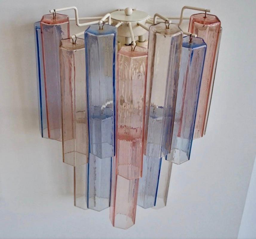 Aureliano Toso Murano glass wall applique with light red, blue and transparent colors. The glass tubes are hanging from a metal base attached to the wall.
Please note that there is only one lamp available, not four as pictured.