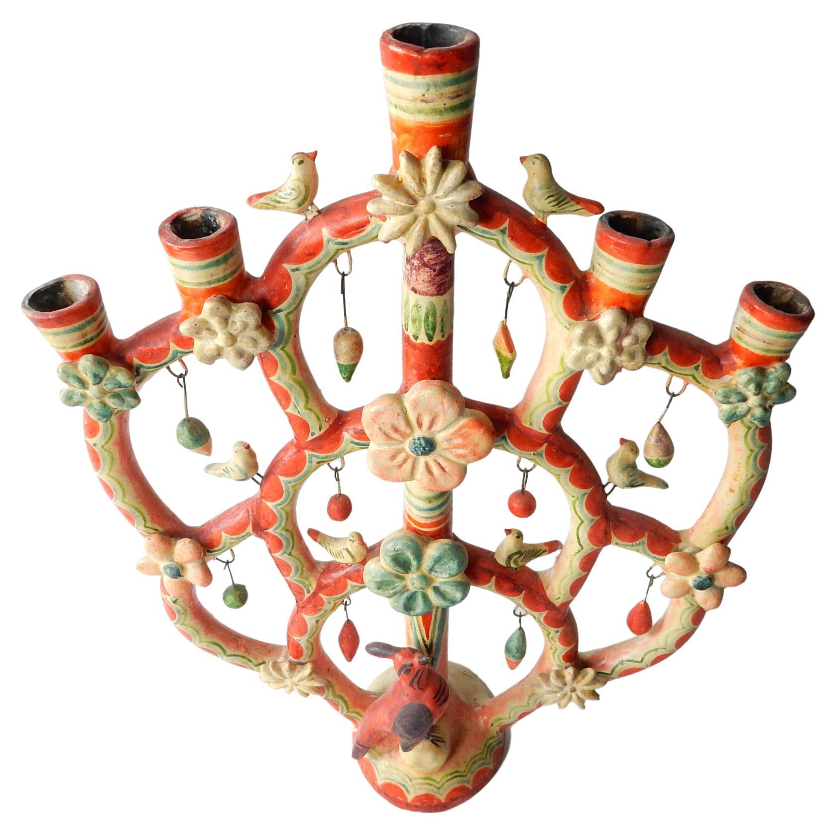 A rare, fine example of a Tree of Life candelabra by Aurelio Flores, circa 1950.
Aurelio Flores (1901-1987), the grandson of potters, began working as a child helping his parents. From the traditional candelabra and incense burners made for