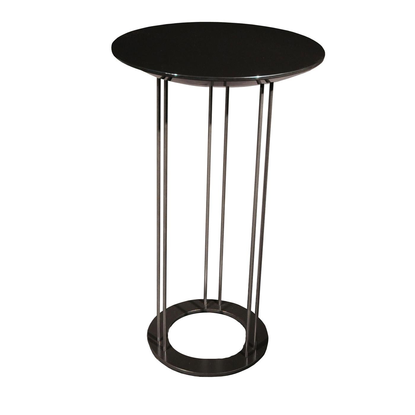 Boasting an elegant, total-black look, this exquisite tall coffee table will infuse any interior with subtle sophistication. The metal structure is composed of six slim and long legs divided into three pairs held together by a ring-shaped base, and