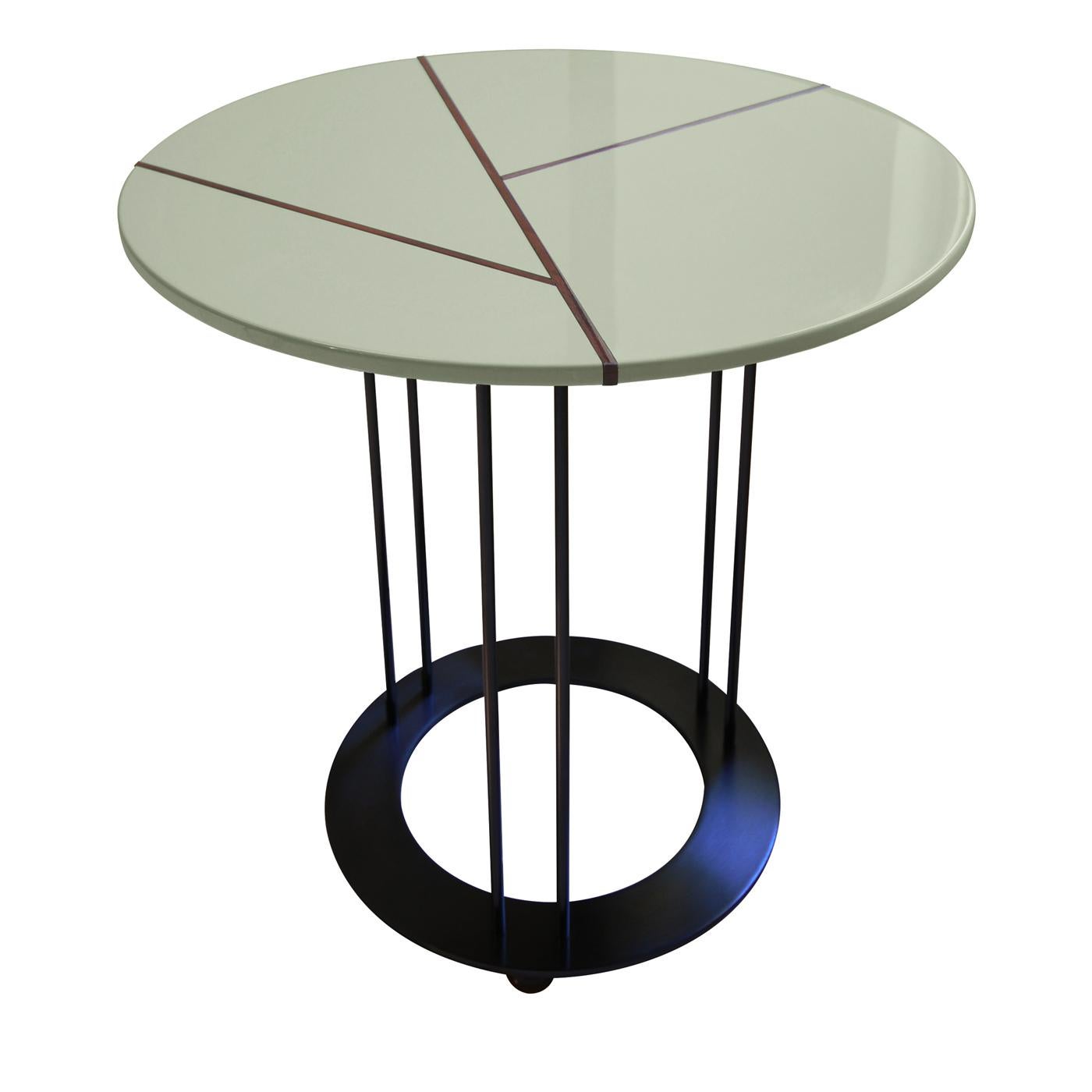 This coffee table has a sophisticated and contemporary allure marked by a unique interplay of leaf patterns. Its striking metal structure with a matte black finish comprises three pairs of slim stems functioning as legs, elegantly resting on a