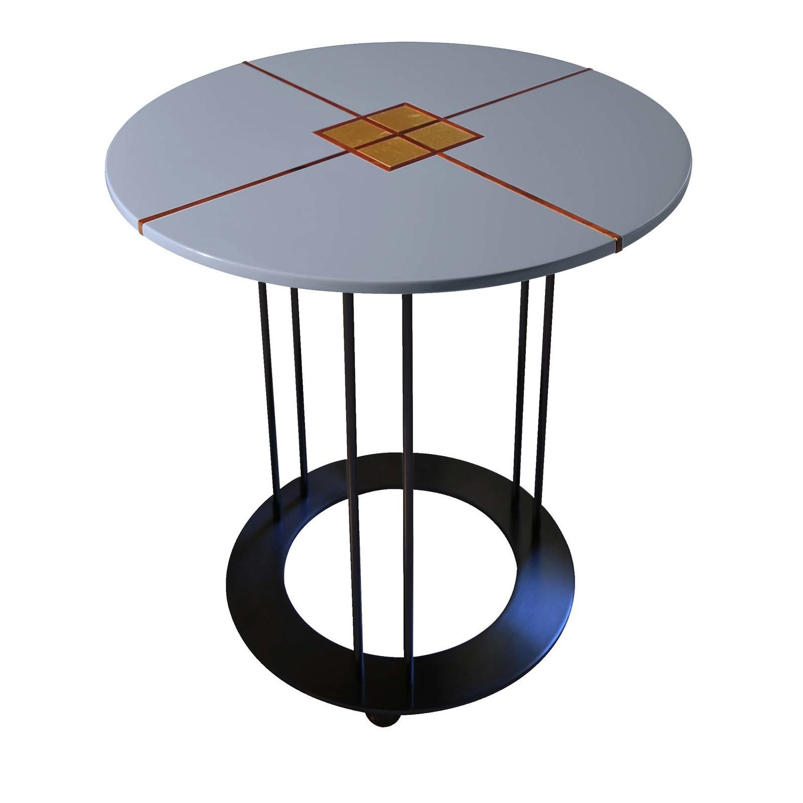 An exercise in minimalism, this elegant side table is defined by a modern profile and will best suit a modern or minimalist interior. The small round top features a glossy, indigo-blue polyurethane lacquer, which contrasts with the cross inlay in