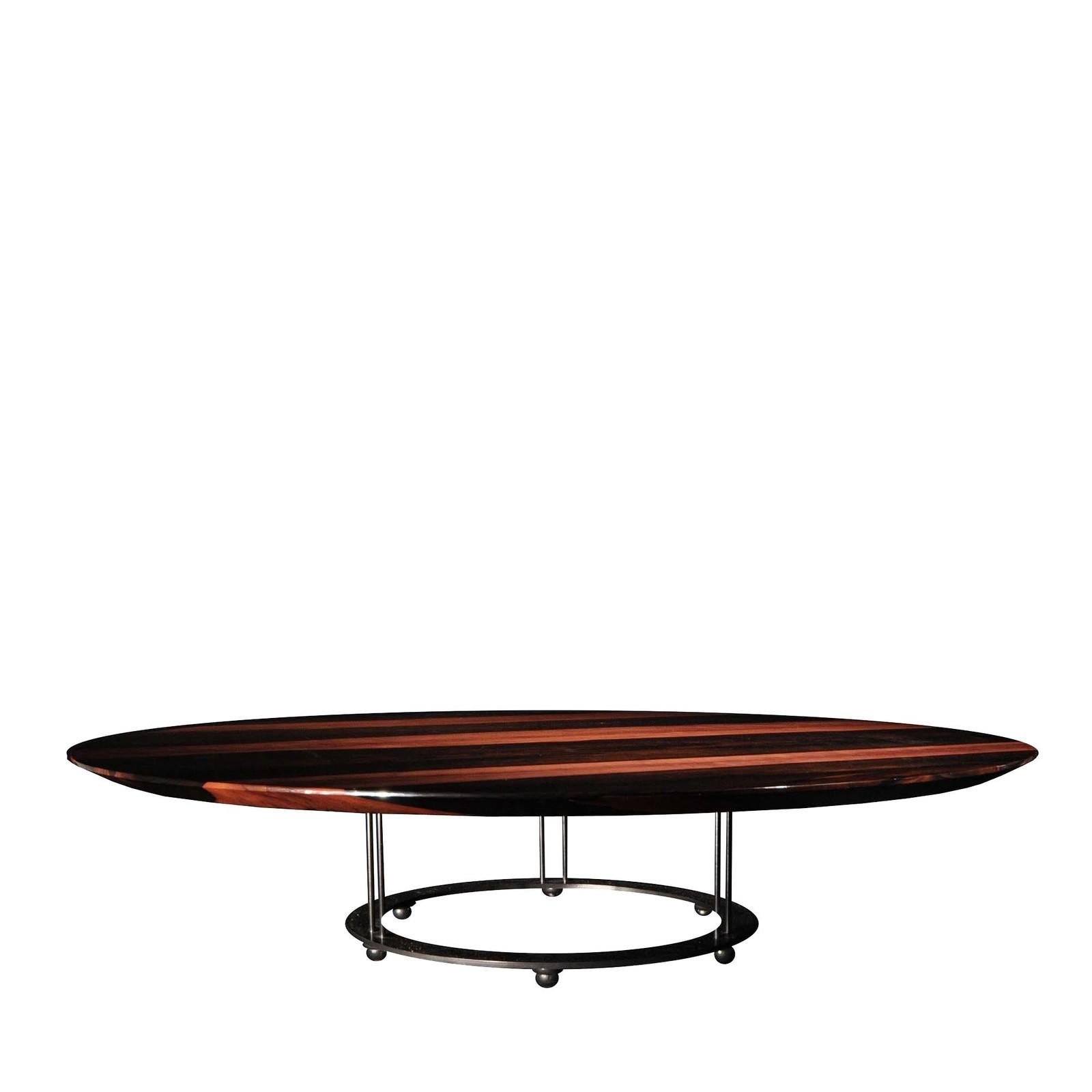 Sculptural in its simplicity, this exceptional coffee table boasts subtle contours and bold materials that capture its Minimalist aesthetic. The wide round tabletop is fashioned of Macassar ebony, notable for its rich wood grain with hues of dark