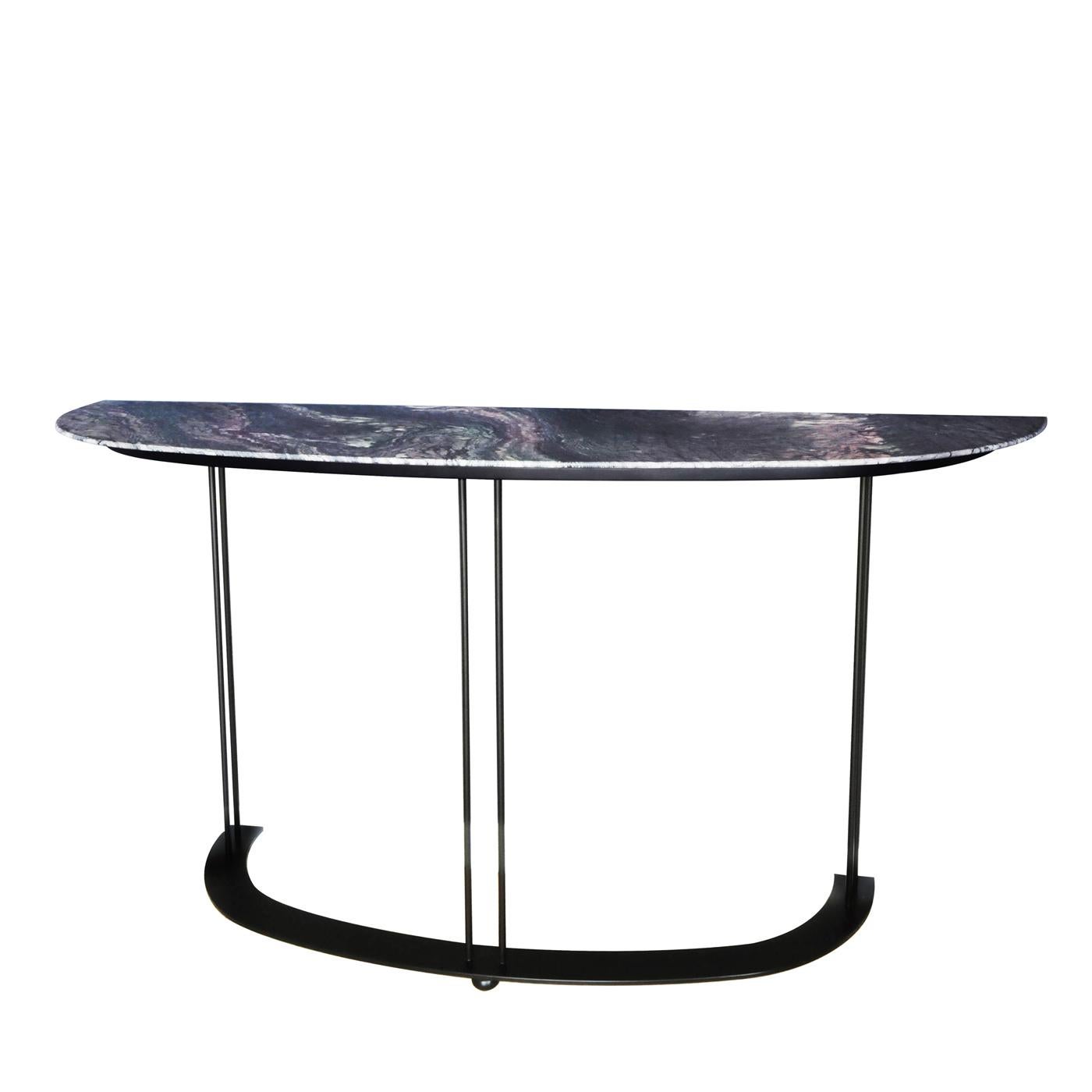 A striking piece of functional decor, this console will elevate the look of an interior. It boasts a magnificent top with a demilune shape, crafted of Red Luana marble showcasing natural veins and hues, and elegantly resting on a metal base with a