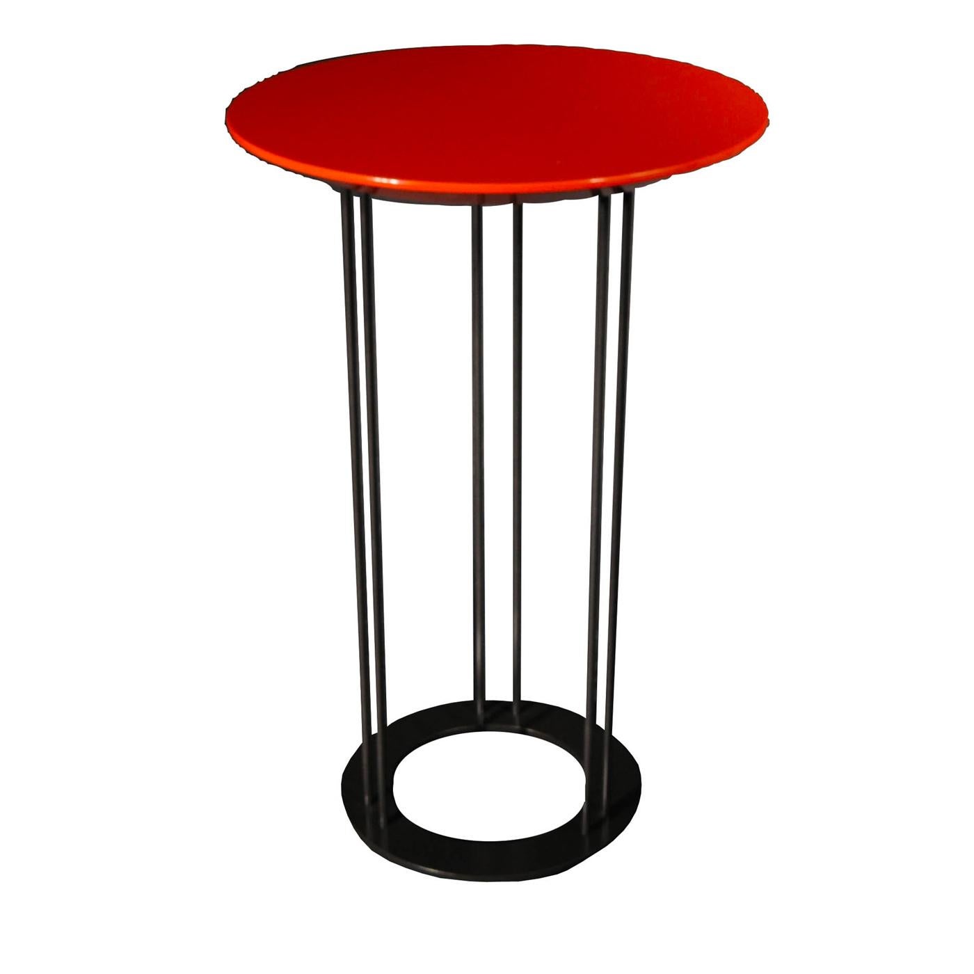 A testament to contemporary aesthetic, this stunning tall coffee table is marked by clean, geometric lines. It features a circular wooden top finished with a shiny coral red polyurethane lacquer, elegantly resting on an eclectic metal structure with