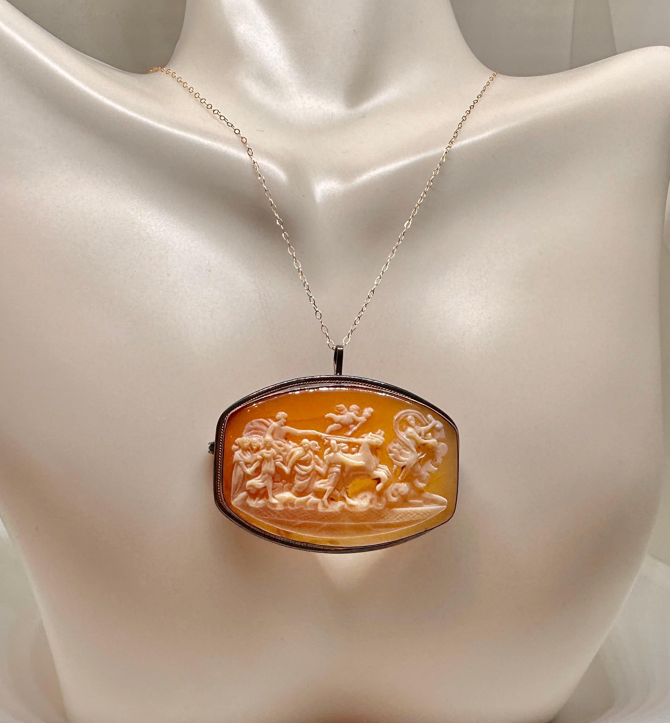 Indulge in a fabulous antique Shell Cameo Pendant Brooch with a hand carved image of Aurora and the Chariot of the Sun driven by Apollo after.  This image is after Reni’s fresco in the Casino dell’Aurora, in the Palazzo Pallavicini, in Rome. It was